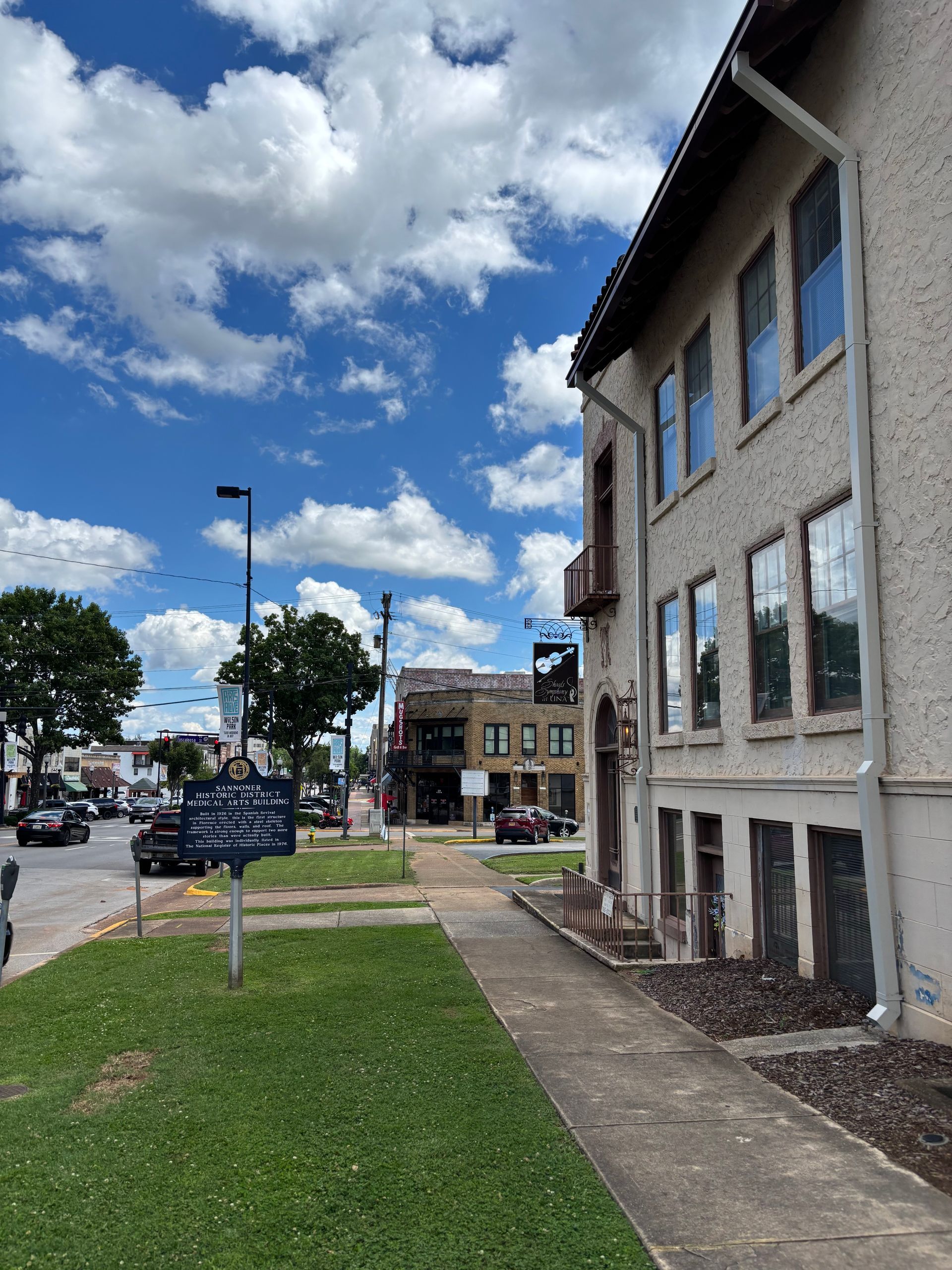 A building with a lot of windows and a sidewalk in front of it