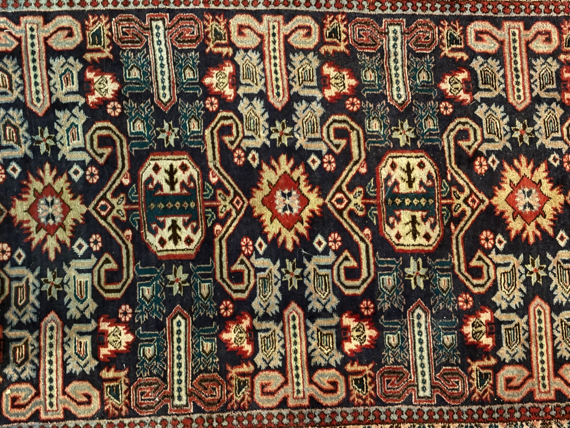 A close up of a rug with a geometric pattern