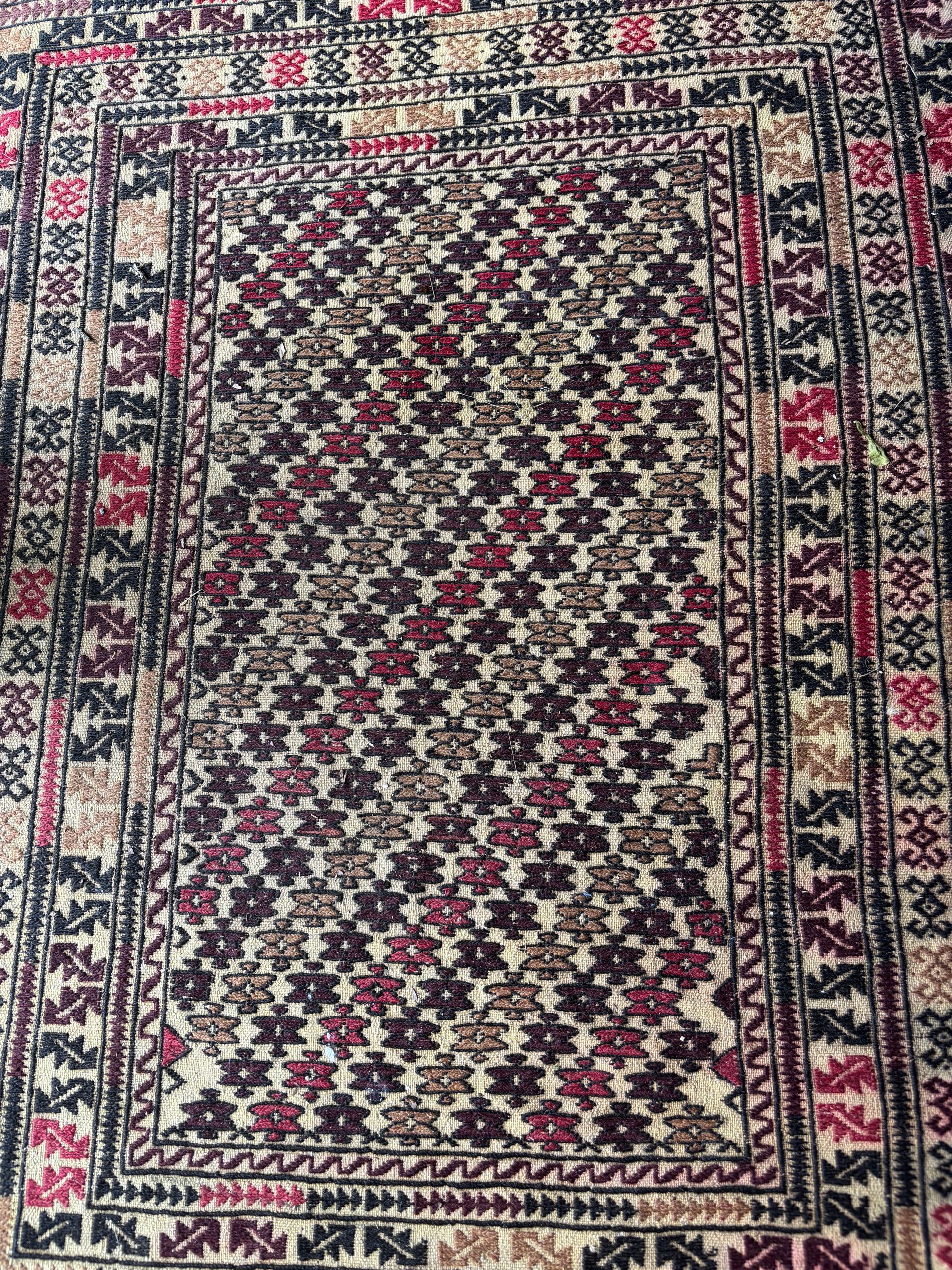 A close up of a rug with a floral pattern on it.