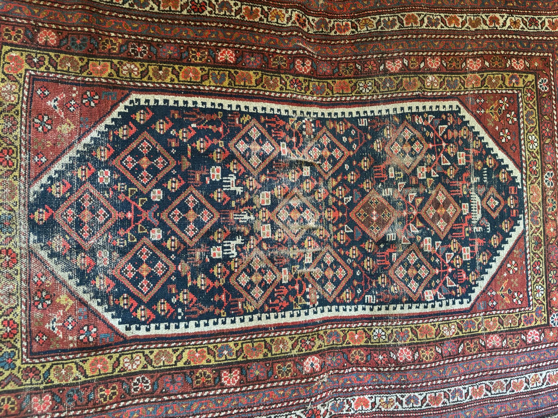 A close up of a rug with a floral pattern on it