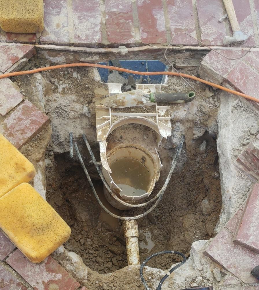 Broken pool skimmer being demolished for replacement.