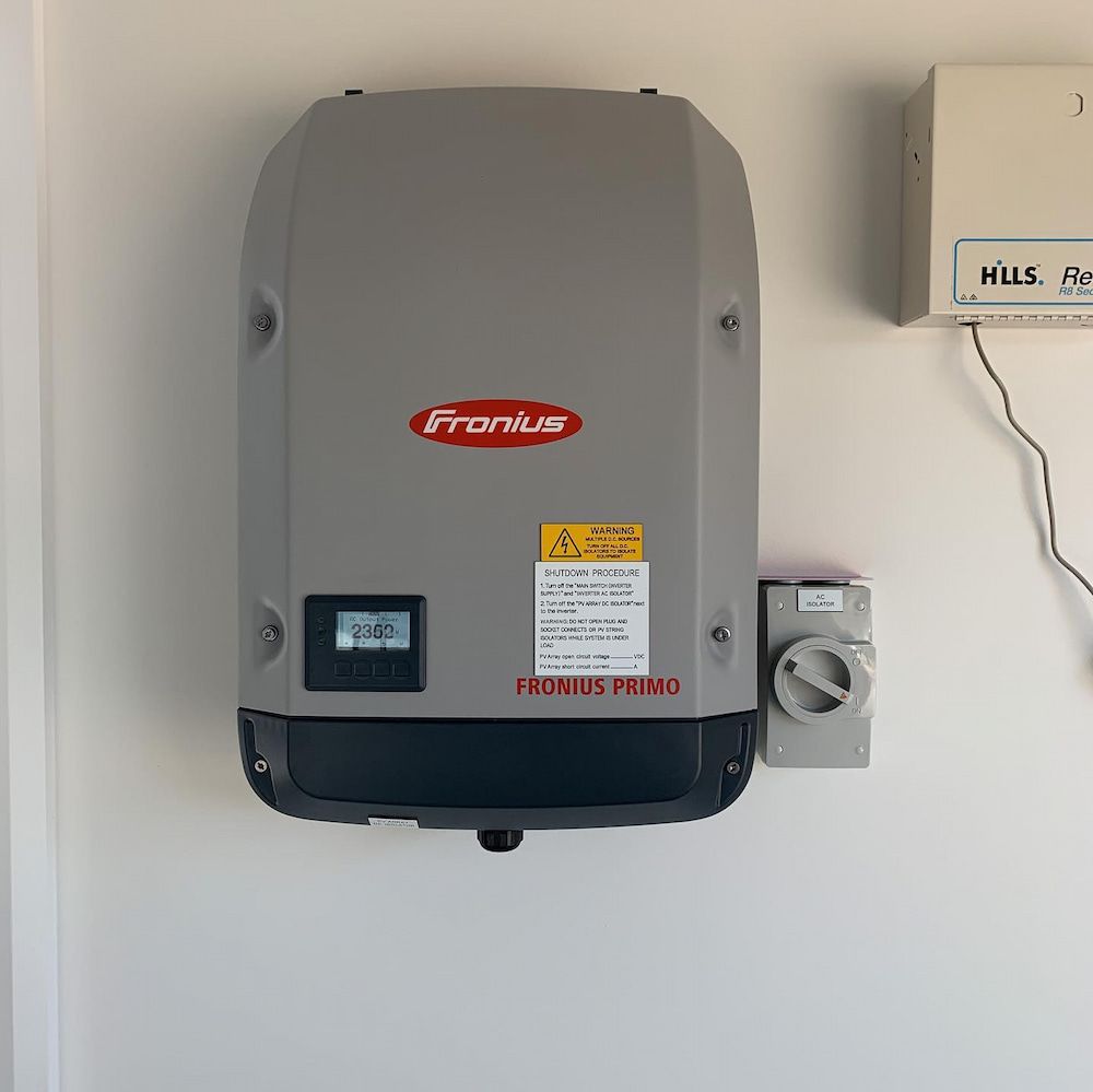 A Fronius Inverter is Mounted on a White Wall — Russell Taber Electrical & Solar in Lake Albert, NSW