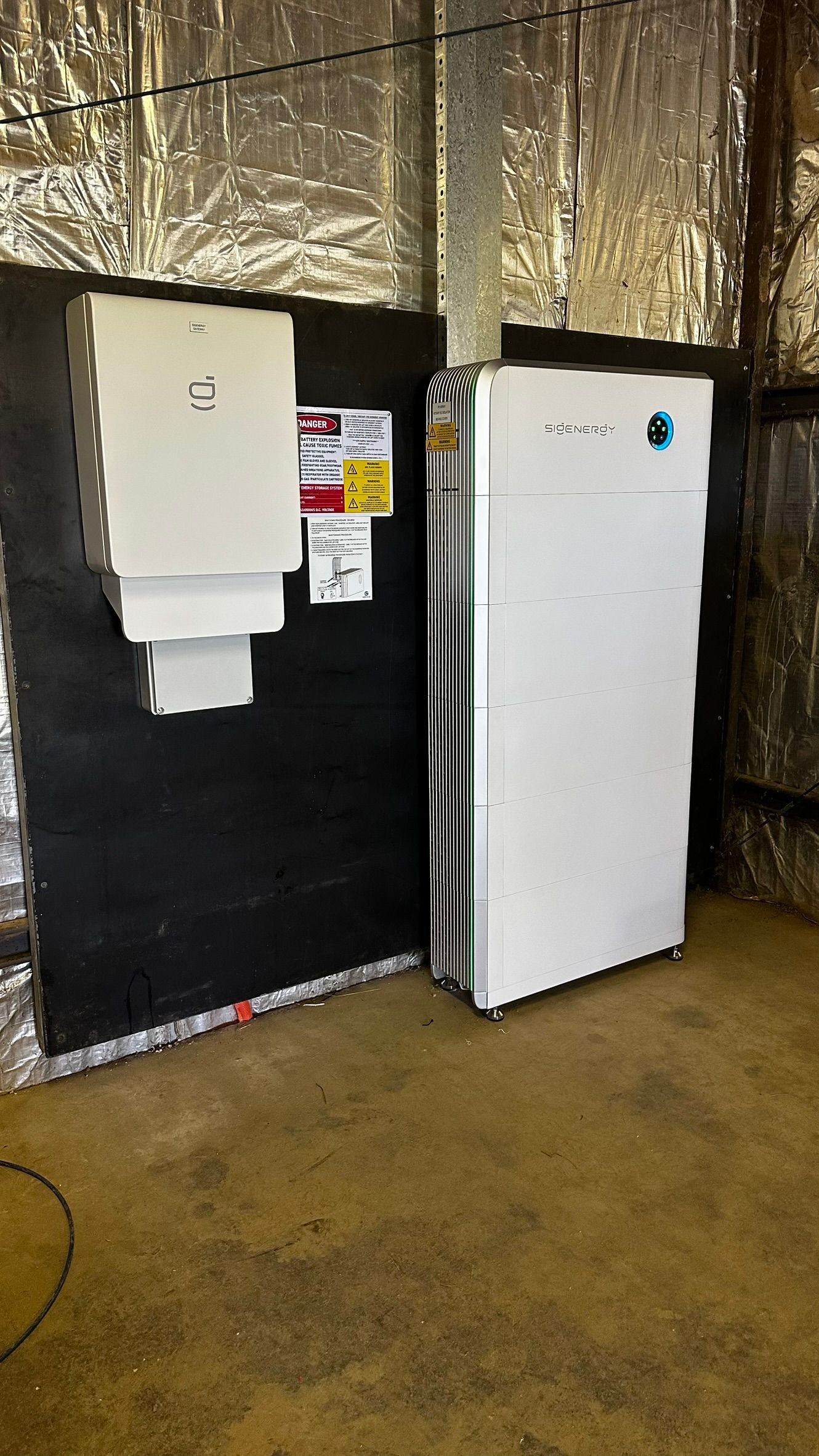 A Solar Battery is Mounted on the Side of a Wall — Russell Taber Electrical & Solar in Lake Albert, NSW 
