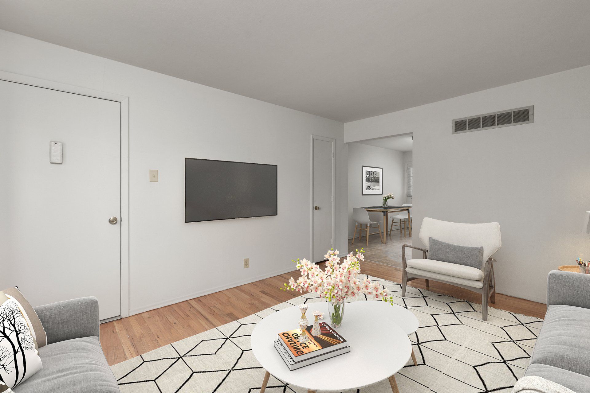 Leslie Apartments living room with couch, rug, and coffee table - furniture for example purposes only.