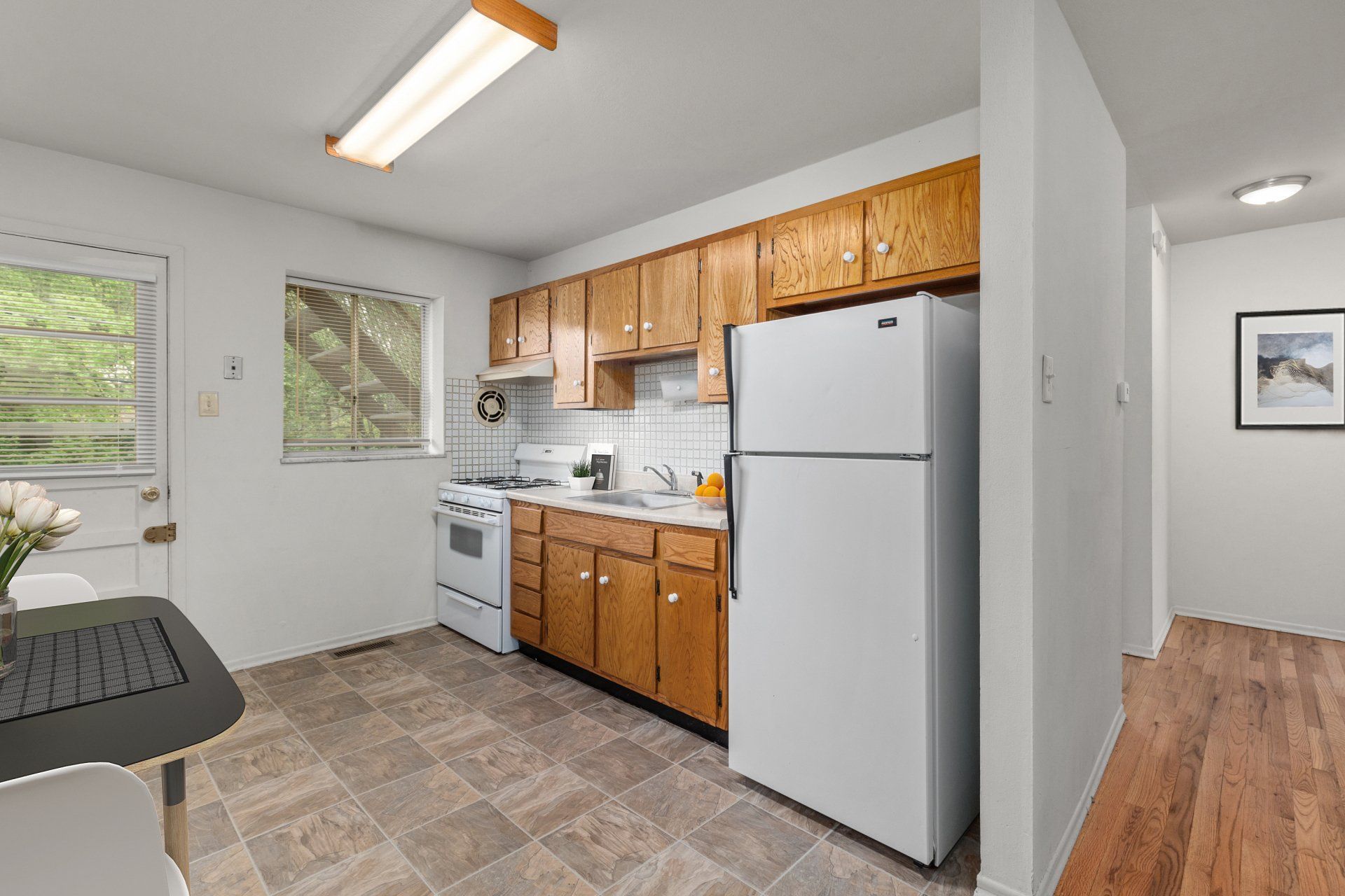 Leslie Apartments kitchen with light wood cabinets