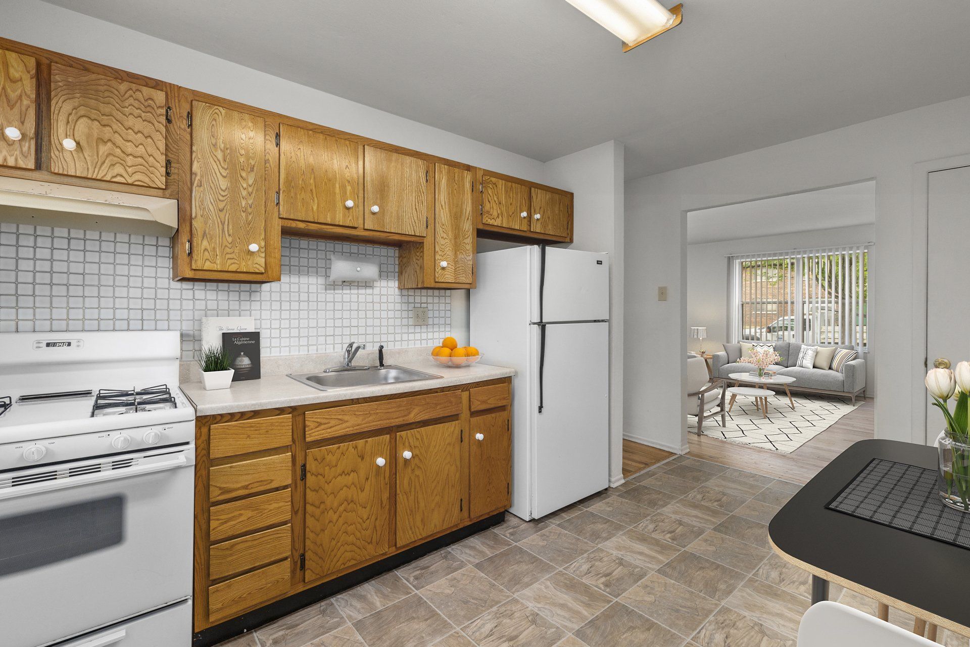 Leslie Apartments kitchen with light wood cabinets