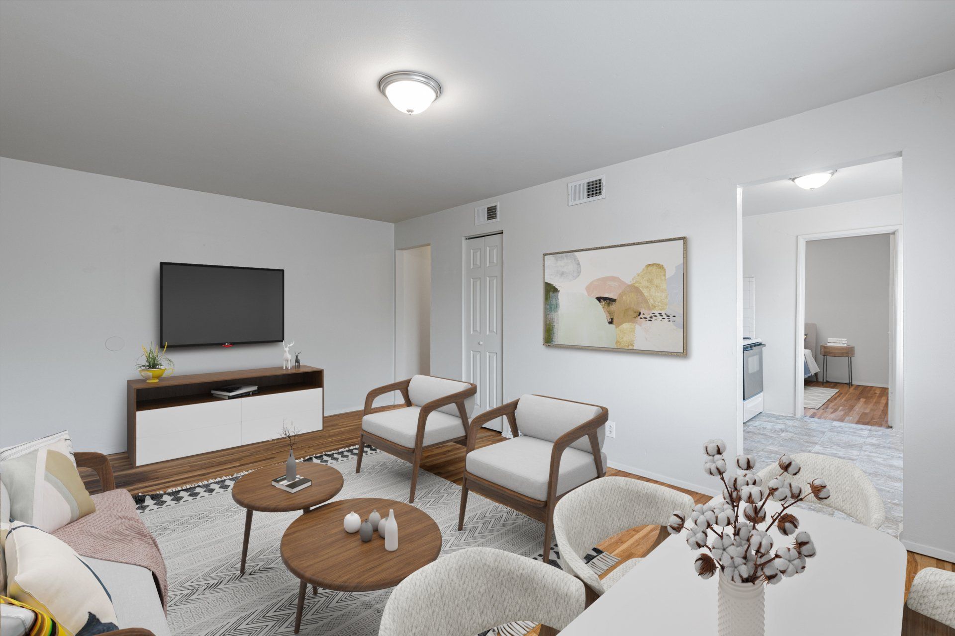 Charbonier Apartments living room with two chairs, coffee table, and tv - furniture for examples purposes only.