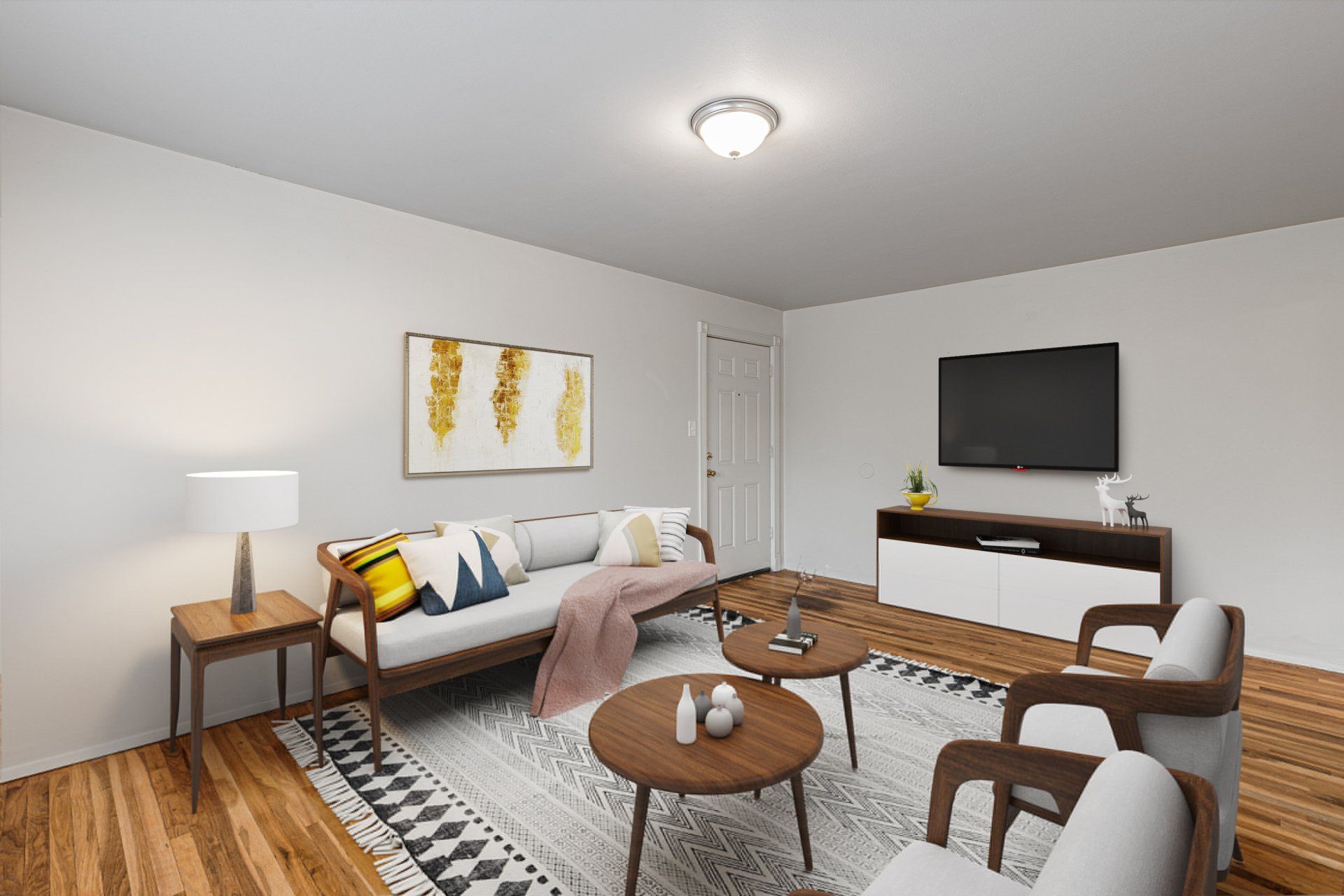 Charbonier Apartments living room with two chairs, coffee table, and tv - furniture for examples purposes only.