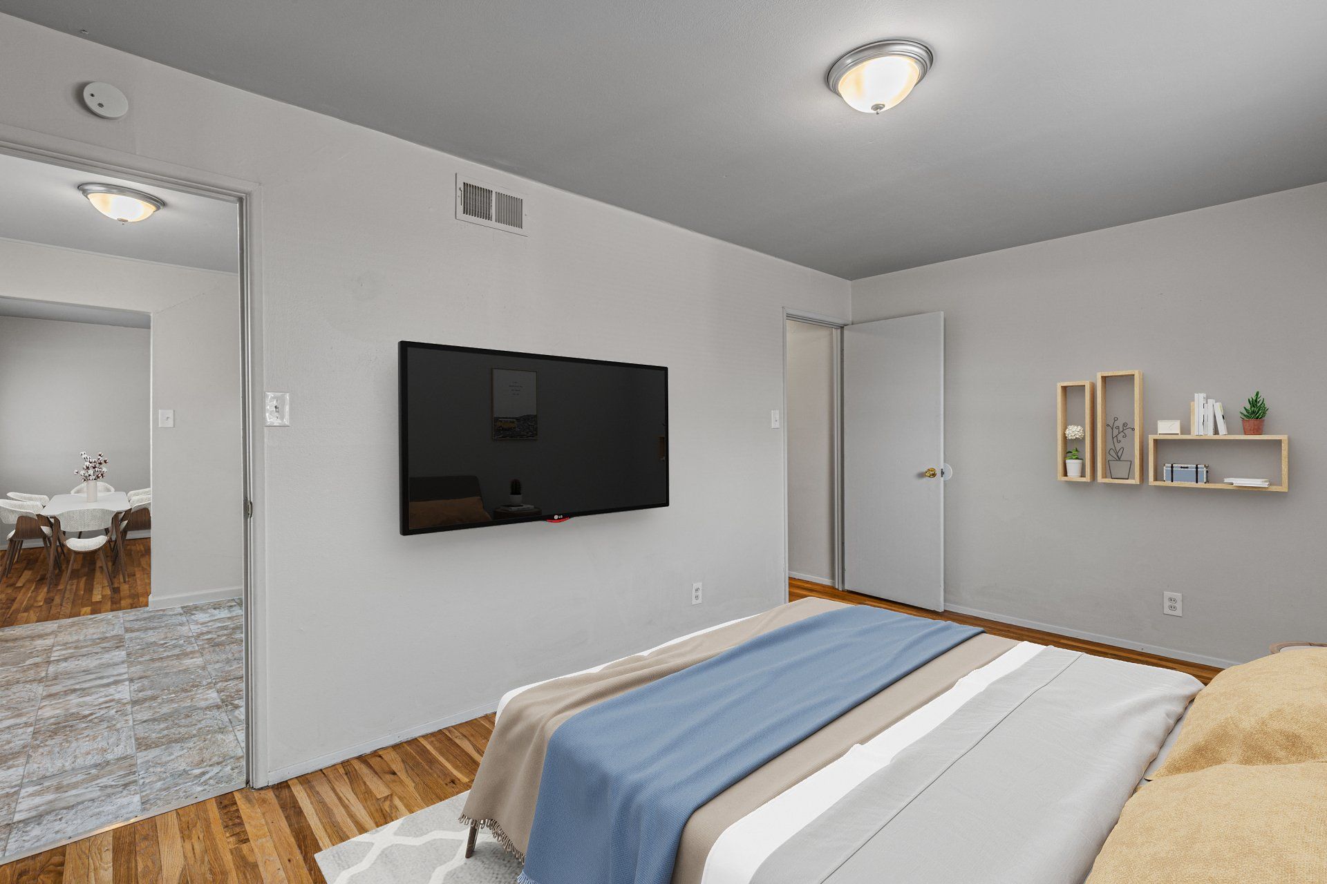 Charbonier Apartments interior bedroom with closet, and bed and tv for example purposes.