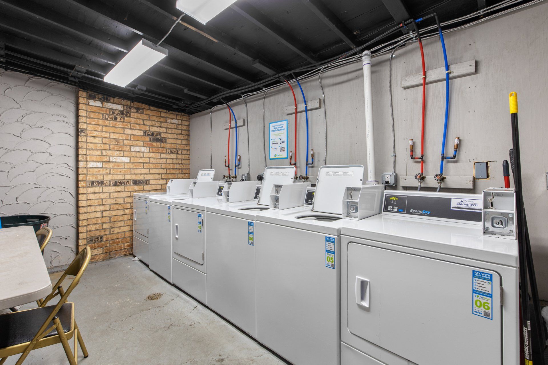 Community laundry room with three washers and three dryers shown in picture.