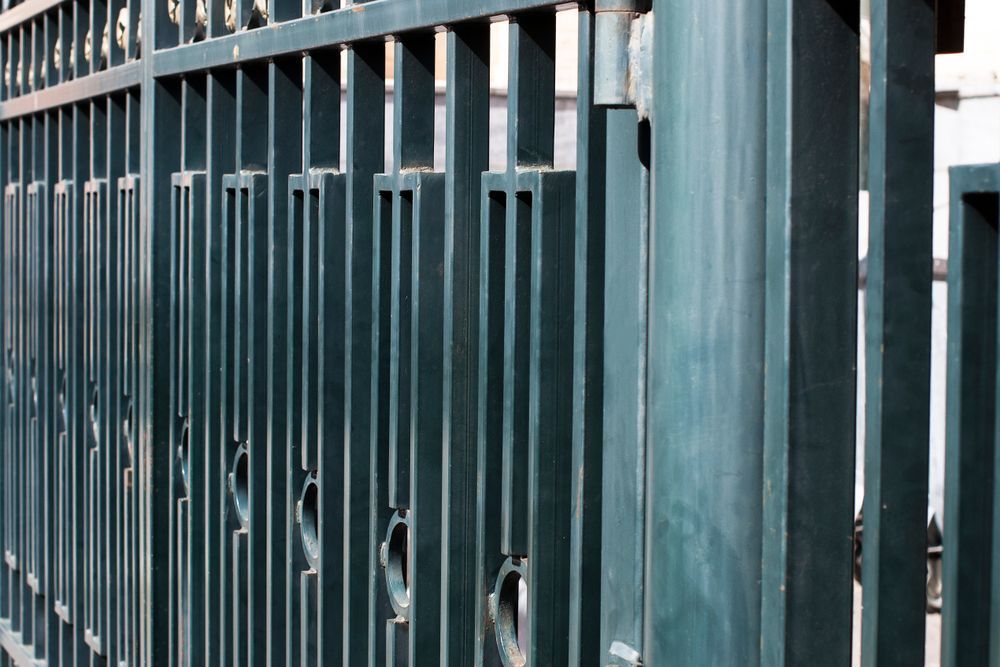 A Dark, Vertically-slatted Metal Fence — PROFENCE AND RETAINING in Beecher, QLD