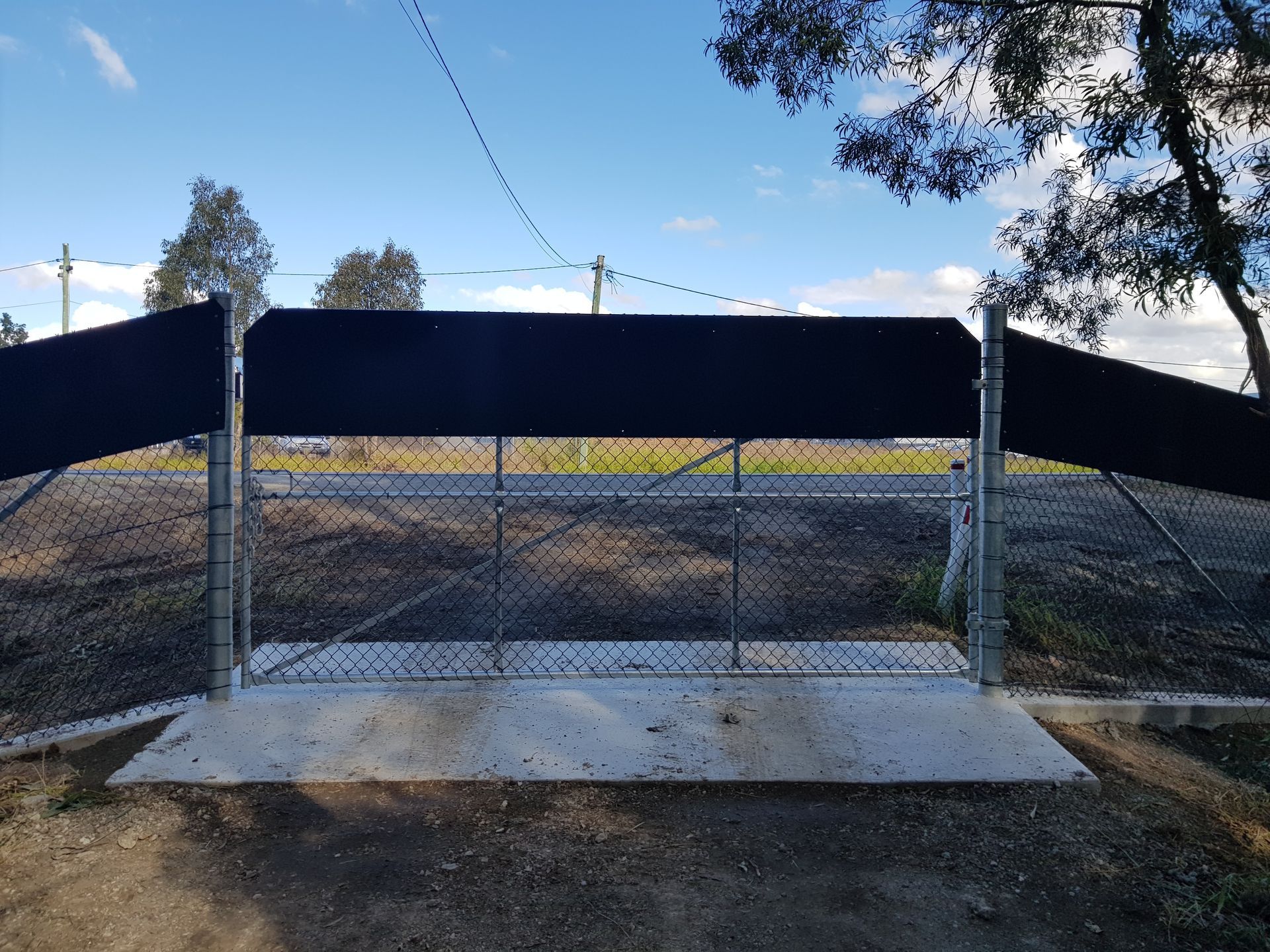 A Chain-link Fence Gate With a Black Privacy Screen — PROFENCE AND RETAINING in Beecher, QLD