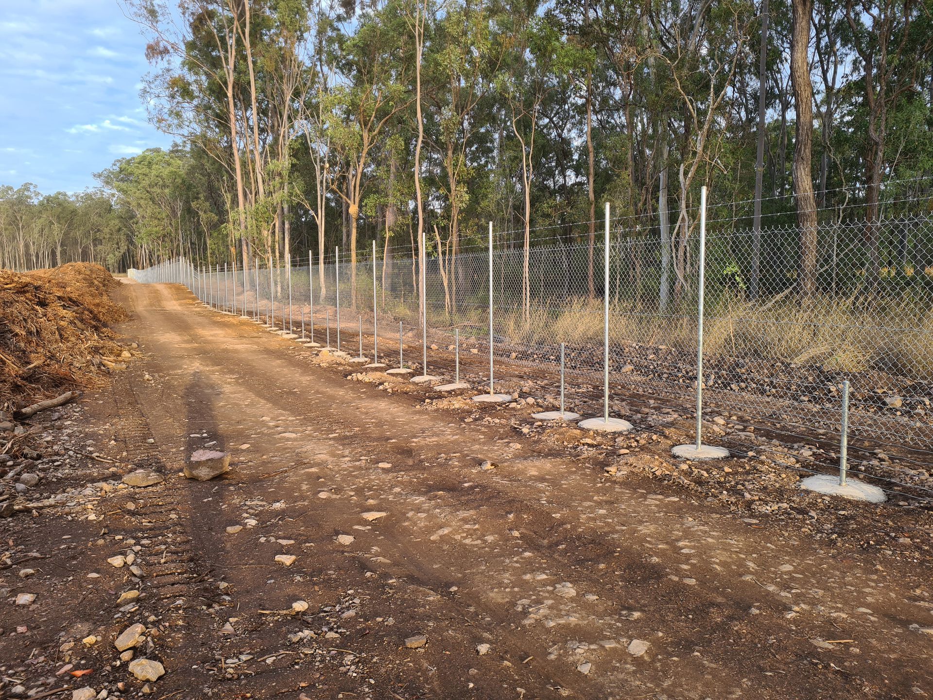 A Line of Metal Fence Posts With Chain-link Fencing Stands — PROFENCE AND RETAINING in Beecher, QLD