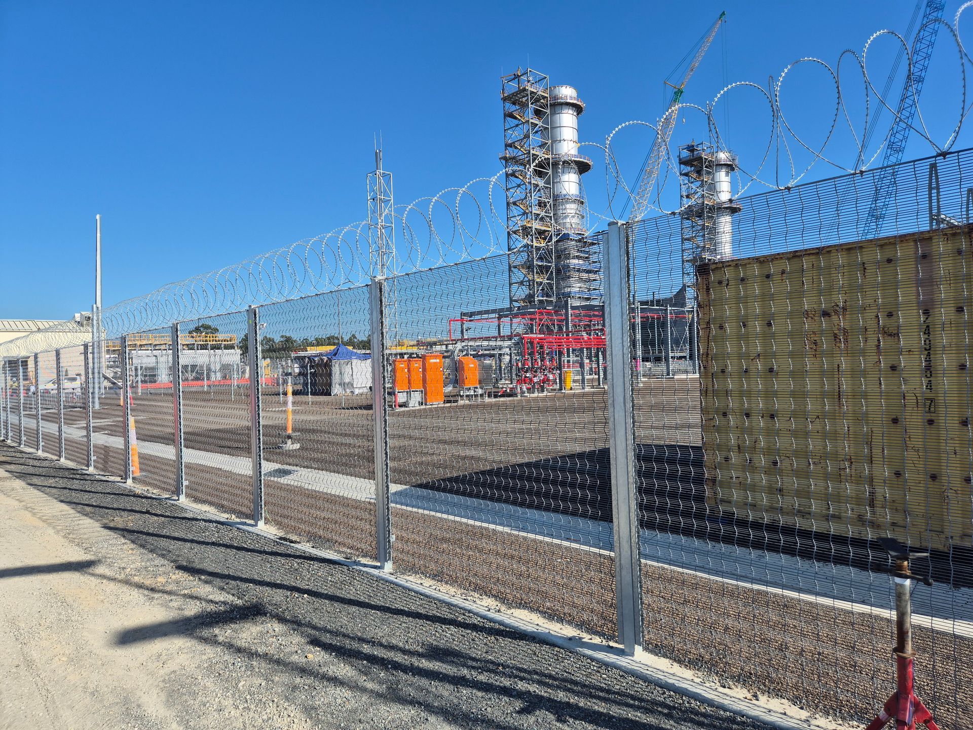 Chain-link Fence Topped With Barbed Wire Surrounds a Construction — PROFENCE AND RETAINING in Beecher, QLD