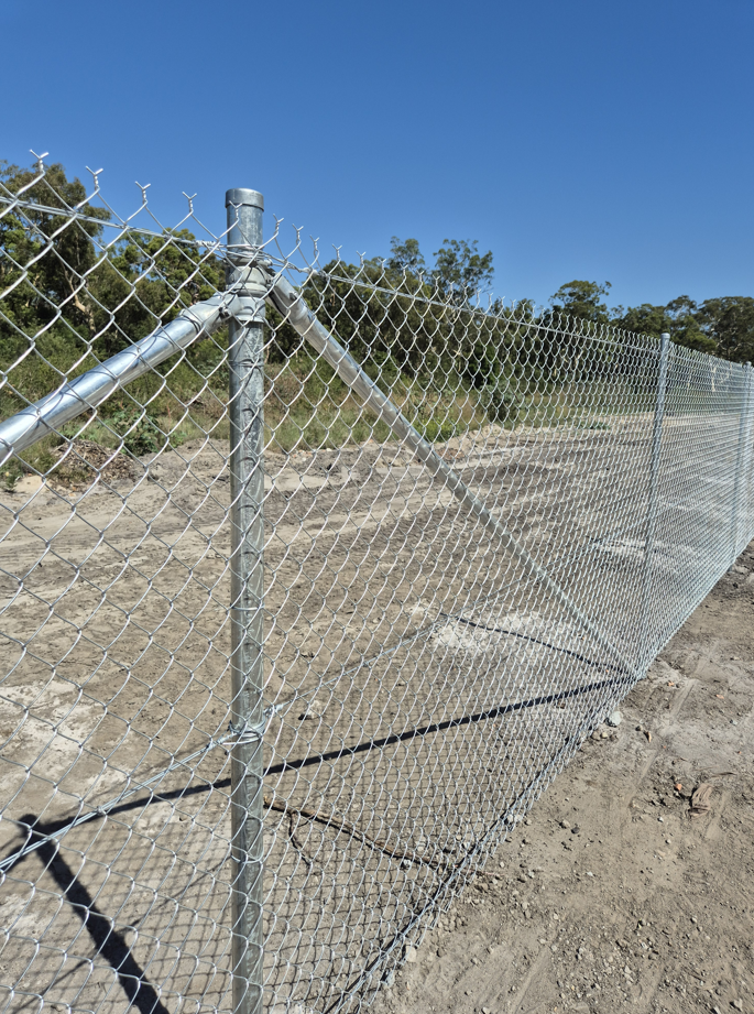 A Metal Chain-link Fence Post With Diagonal Support Rails Stands — PROFENCE AND RETAINING in Beecher, QLD
