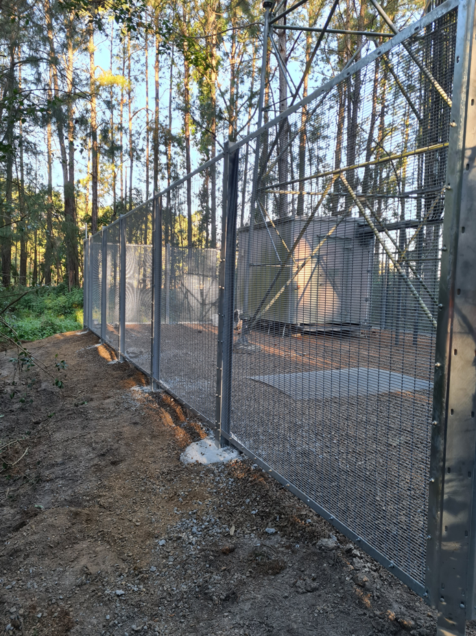 A Fenced Utility Area With a Patterned Metal Mesh Enclosure — PROFENCE AND RETAINING in Beecher, QLD