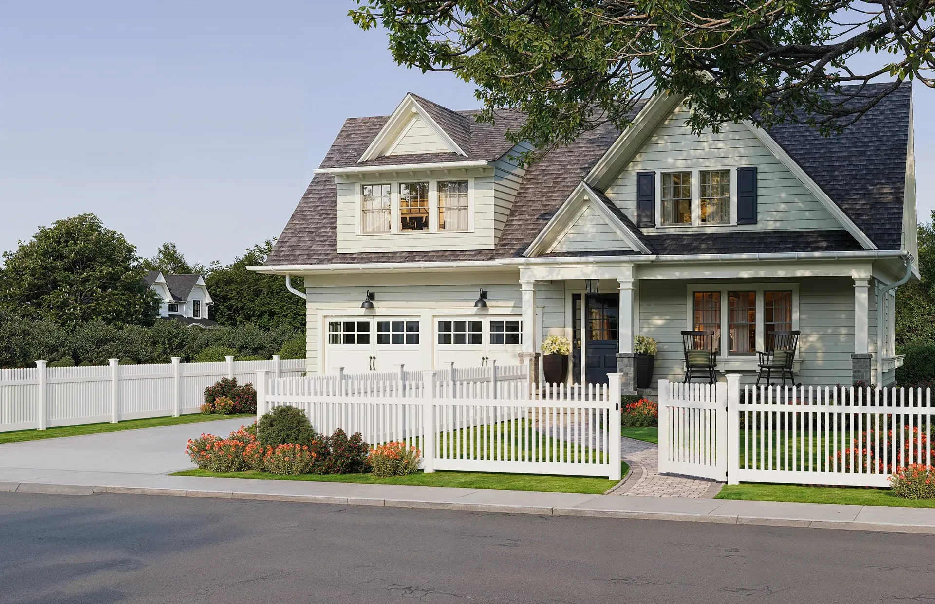 Light green house with white picket fence and two-car garage. A tree shades the porch.
