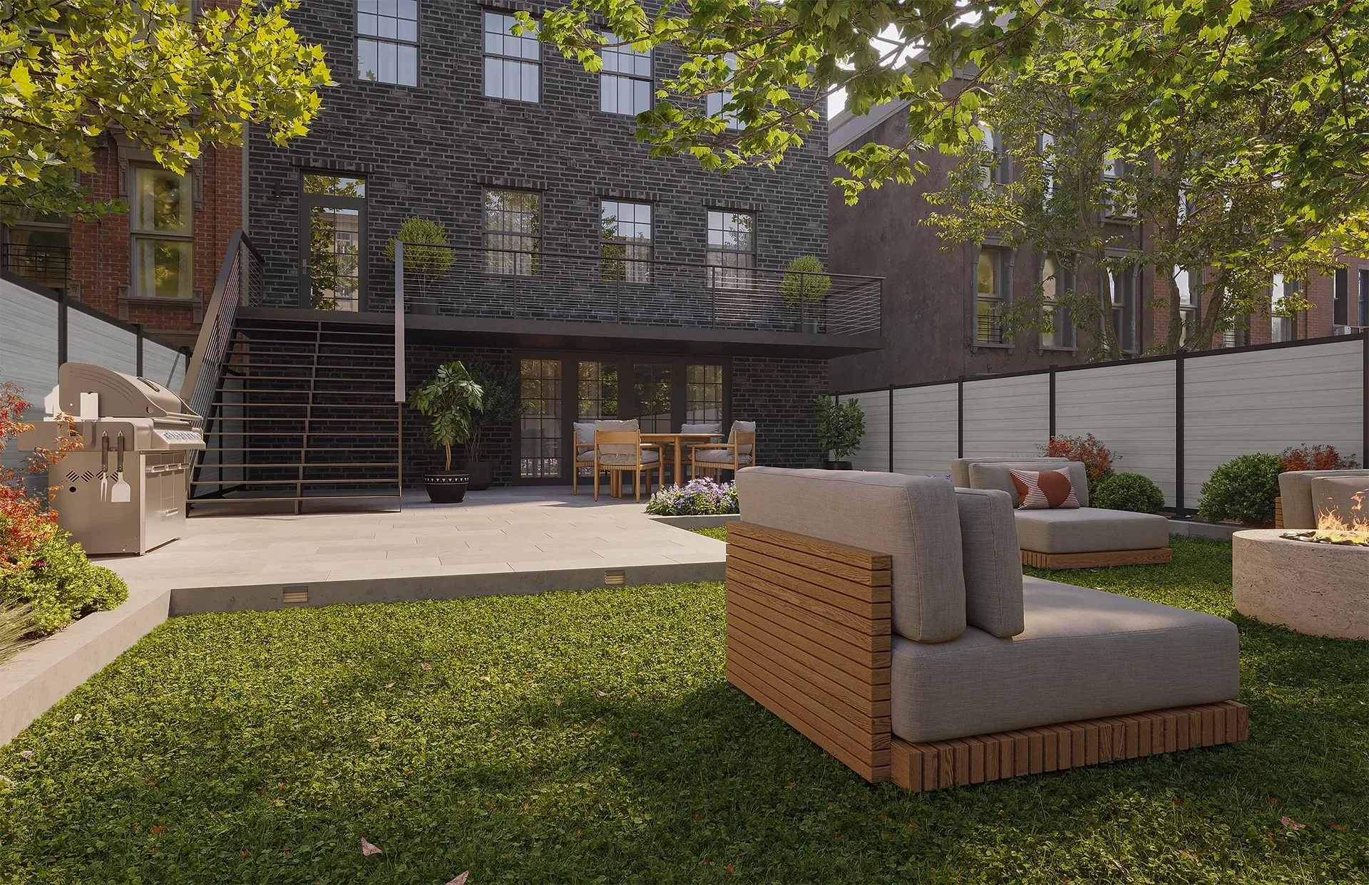 Backyard with modern seating, grill, and a unique wood-clad building. Green grass, trees.