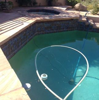 A swimming pool with a hose in the middle of it