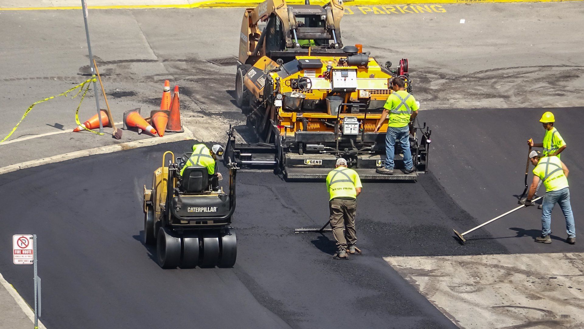 A group of construction workers are working on a road