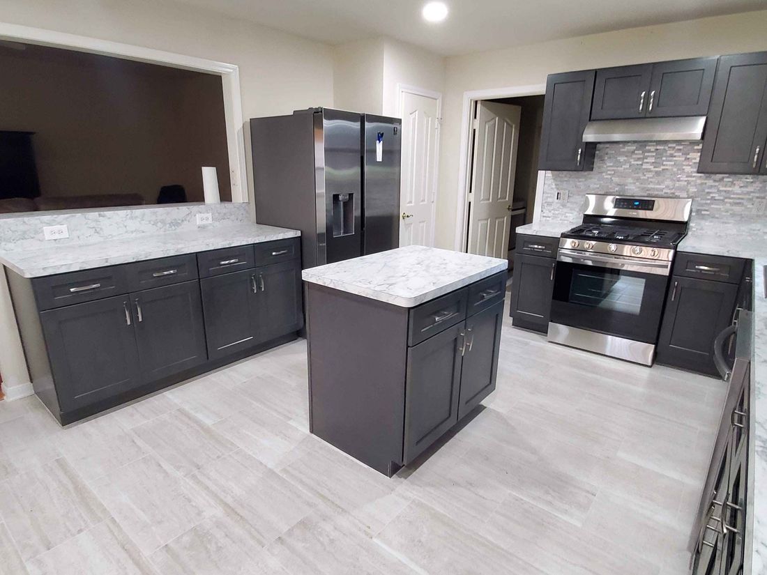 big kitchen with countertop and wood flooring