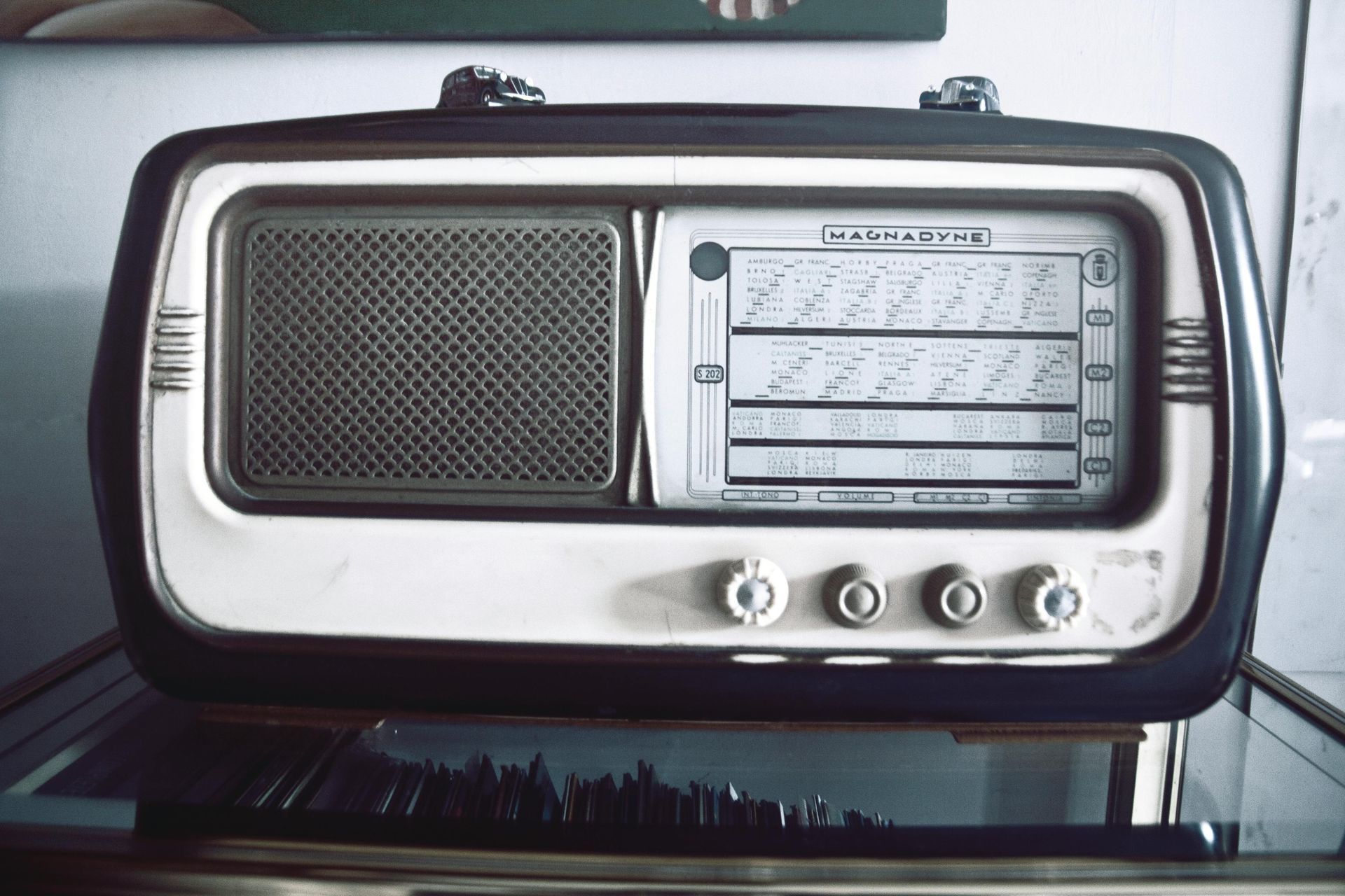 Couple on a sofa listening to a retro radio in a light-filled living room.