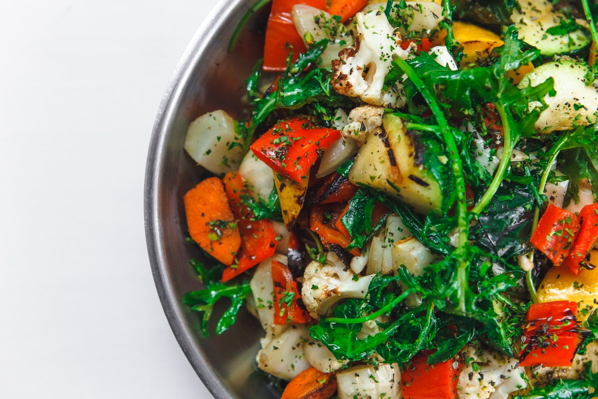 A close up of a plate of vegetables on a table.