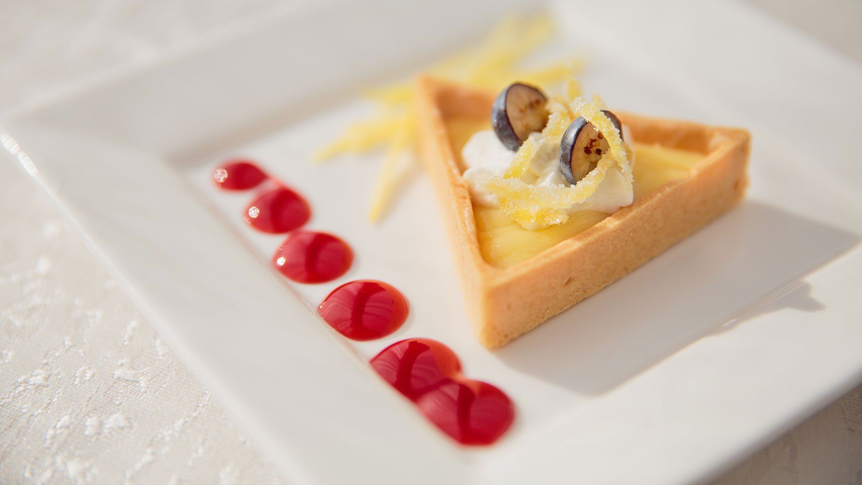 A close up of a dessert on a white plate on a table.