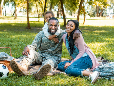 Military dad with wife and kid during outdoor picnic