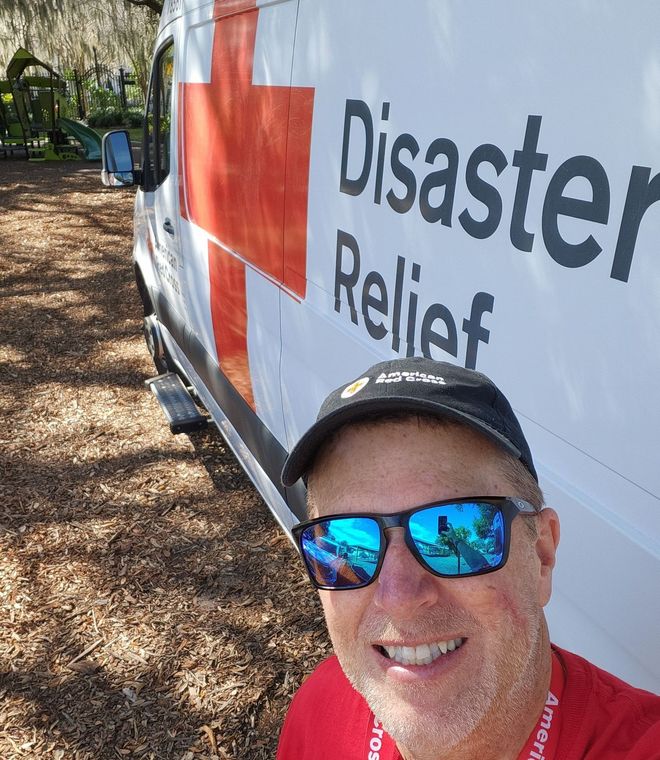 a selfie of allen fetters in front of an american red cross van