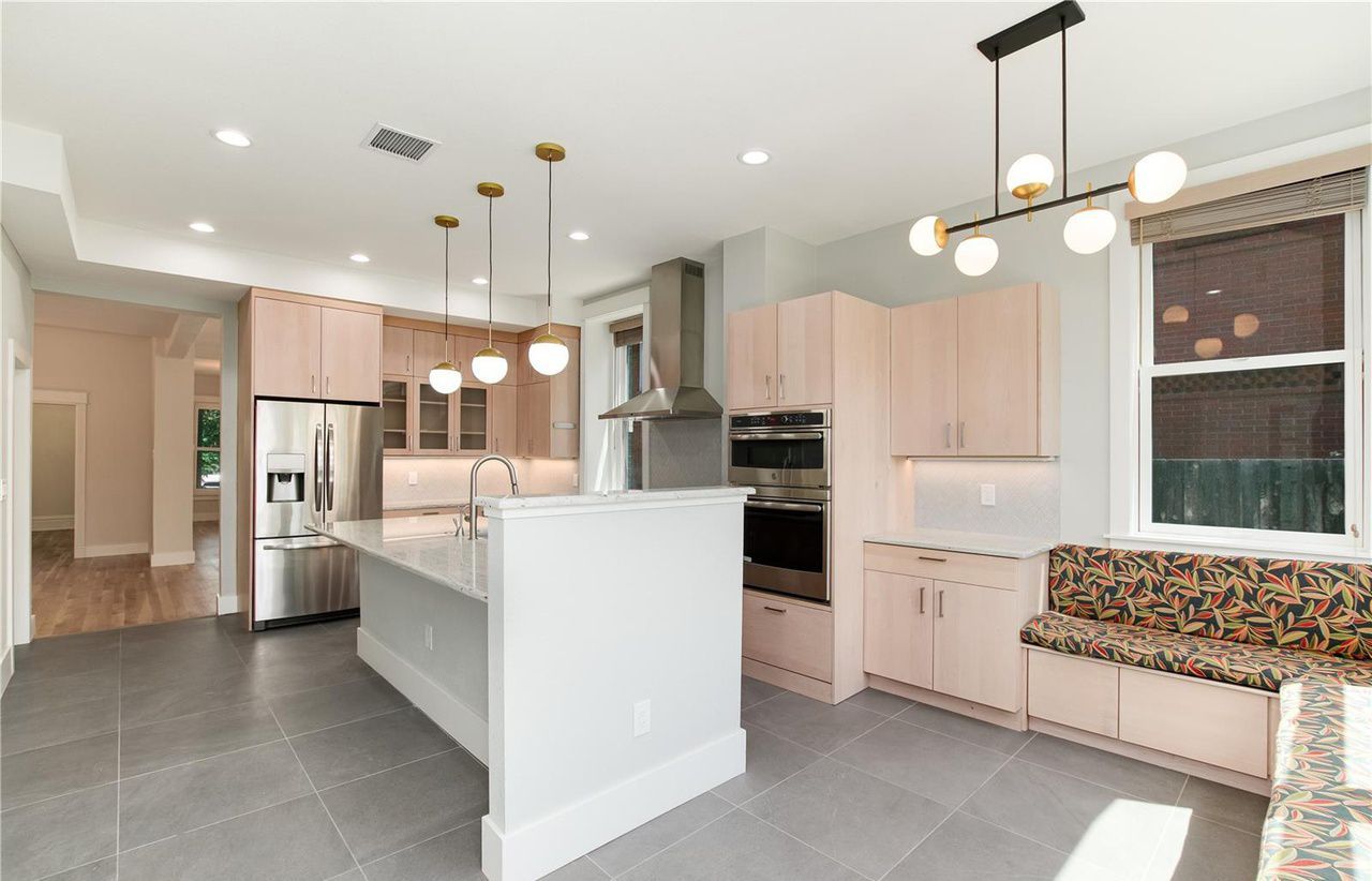 A kitchen with a large island and stainless steel appliances.