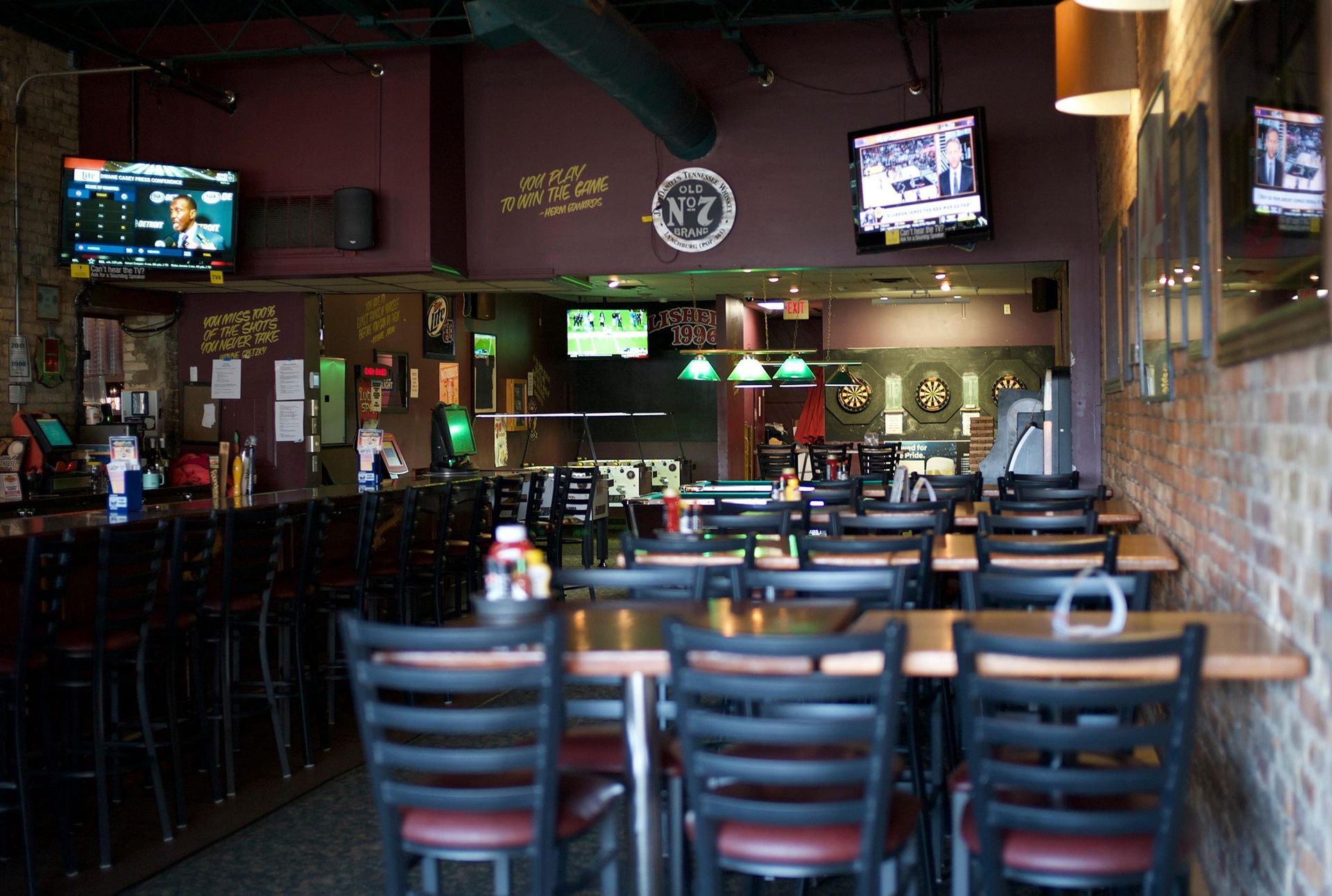 A restaurant with tables and chairs and a bar