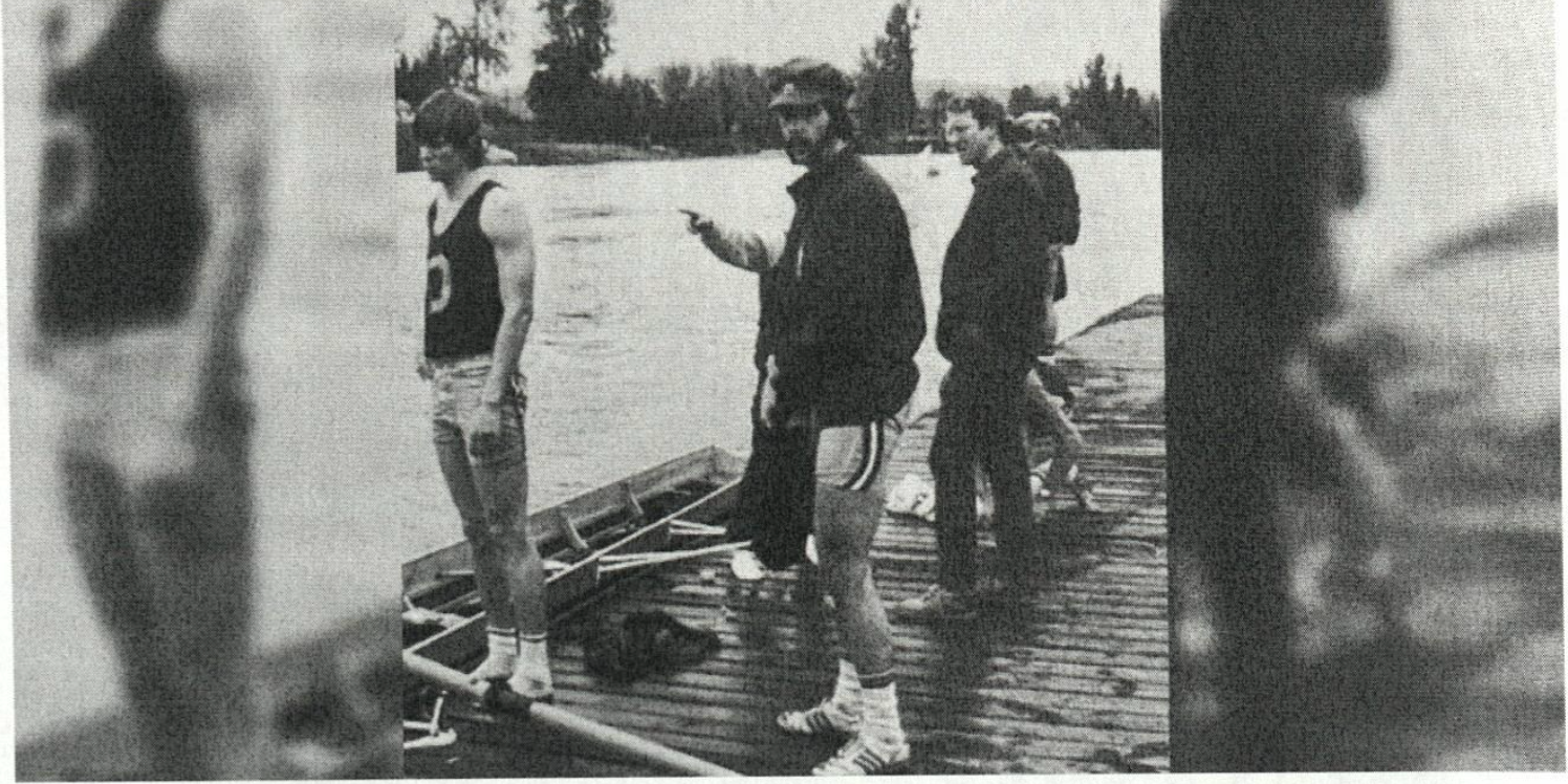 black and white photo of men standing around fishing boat