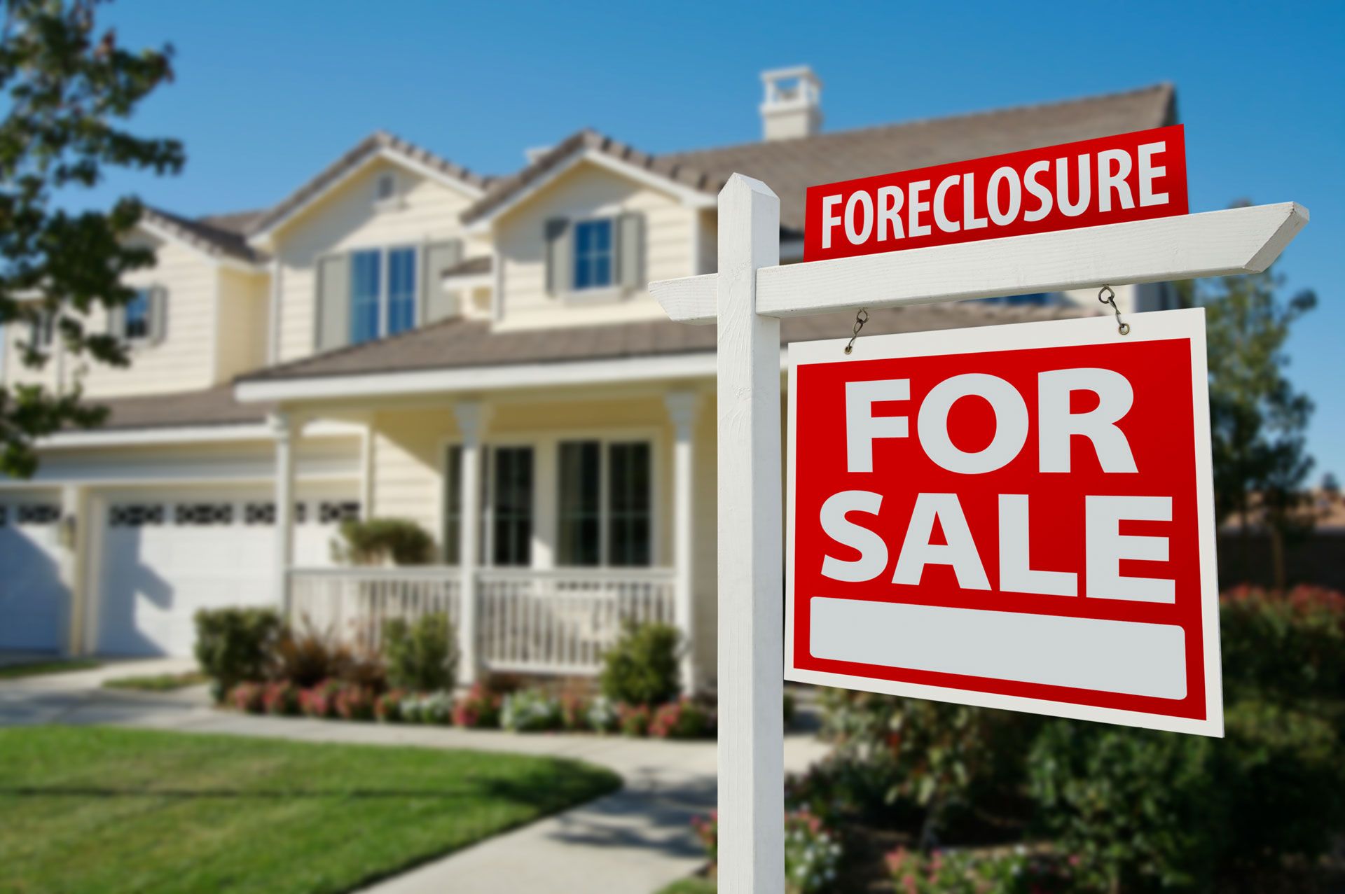 A house with a foreclosure sign in front of it