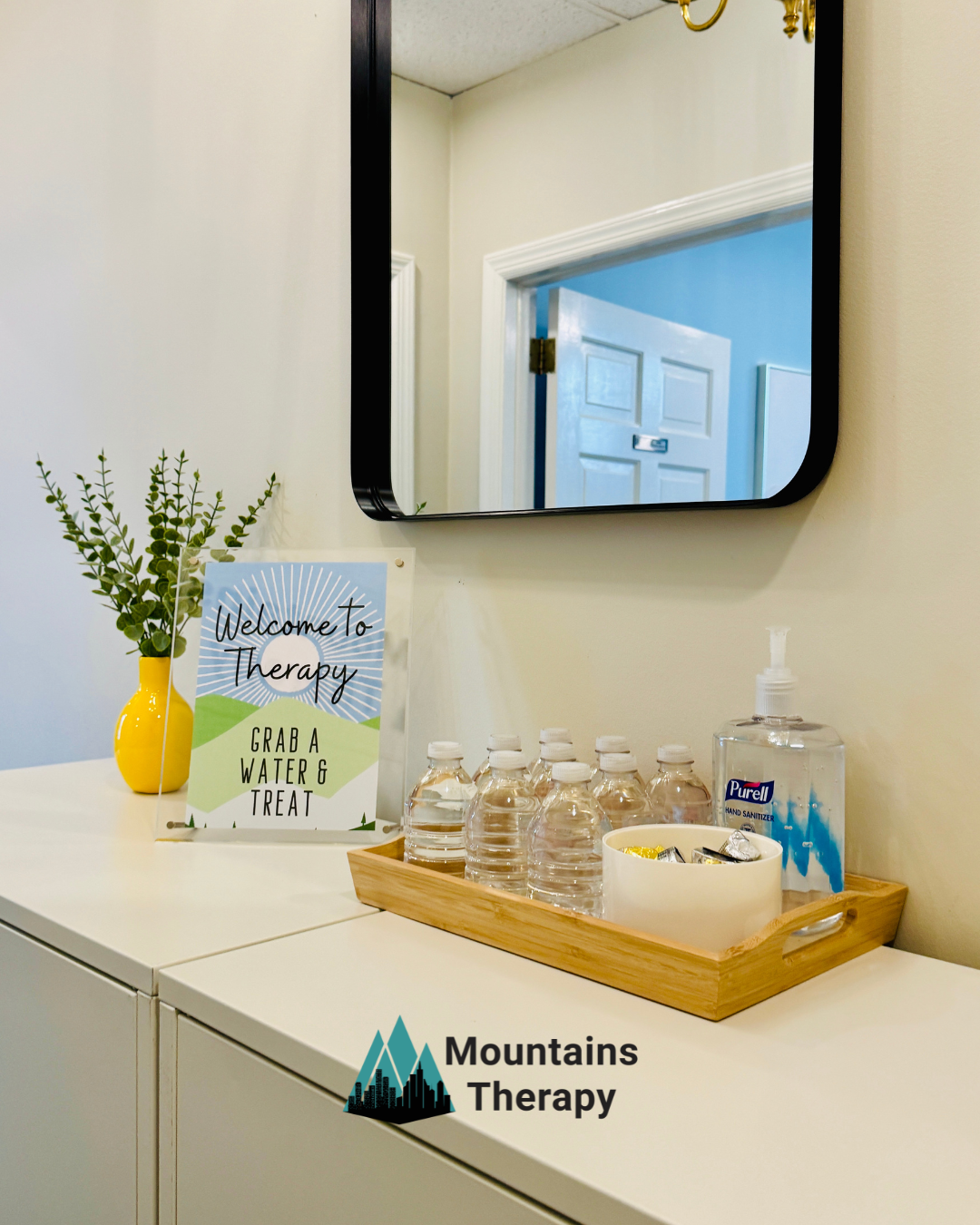 White cabinet with water bottles, hand sanitizer, and a