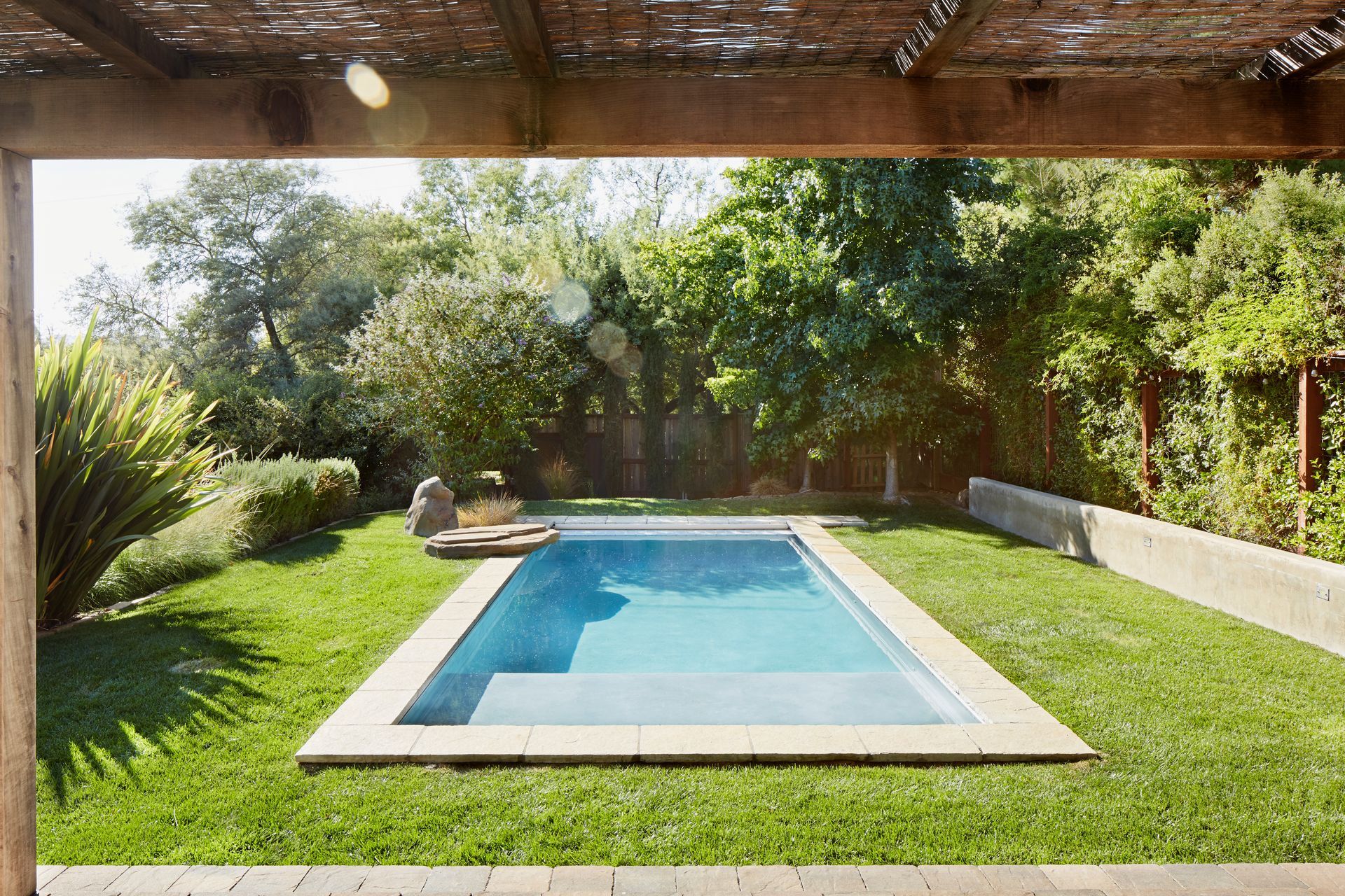 Small pool in a backyard, showcasing pool fence compliance.