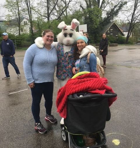 A group of people are posing for a picture with a bunny mascot.