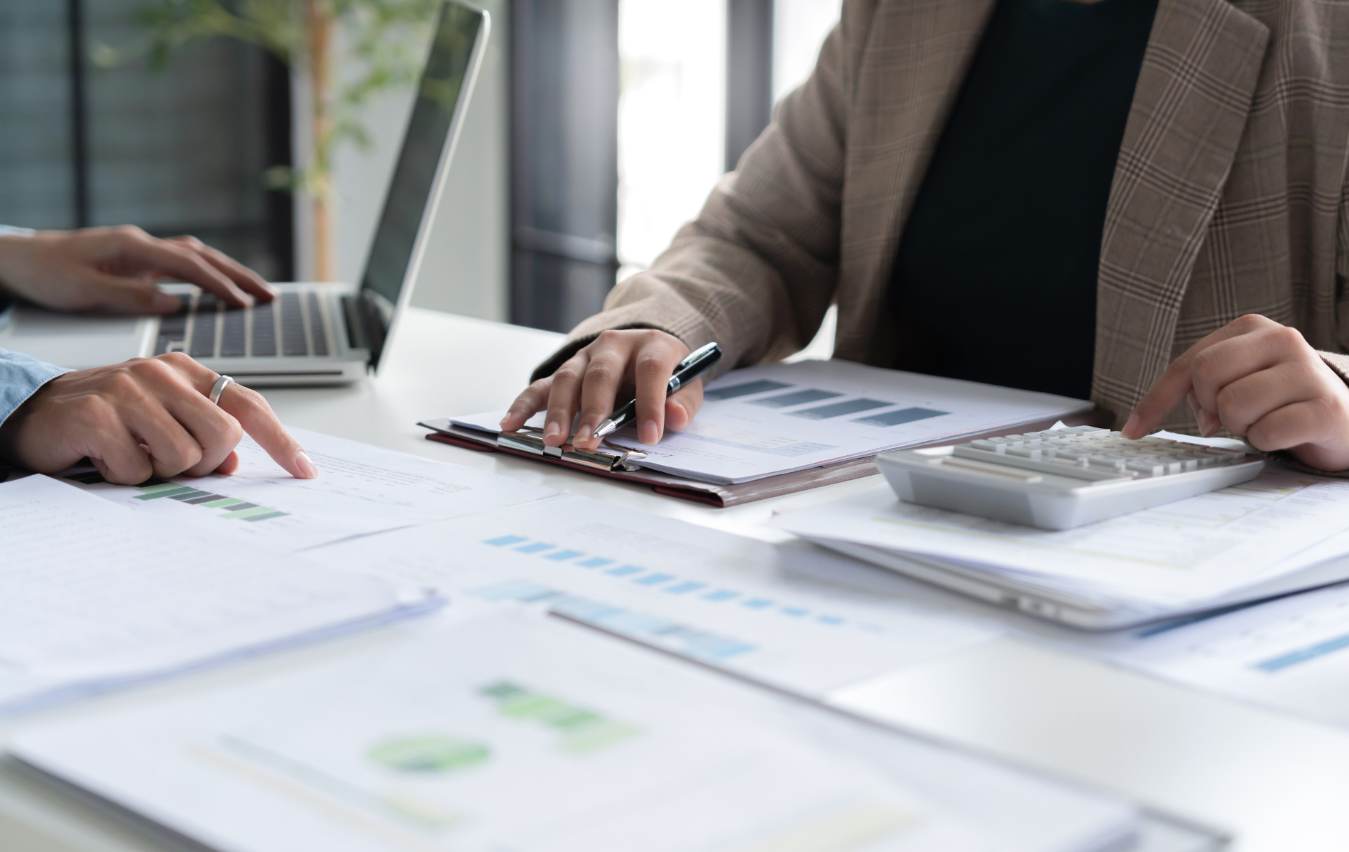 Yellow vinyl being fed into a wide-format cutting machine, person's hands visible.
