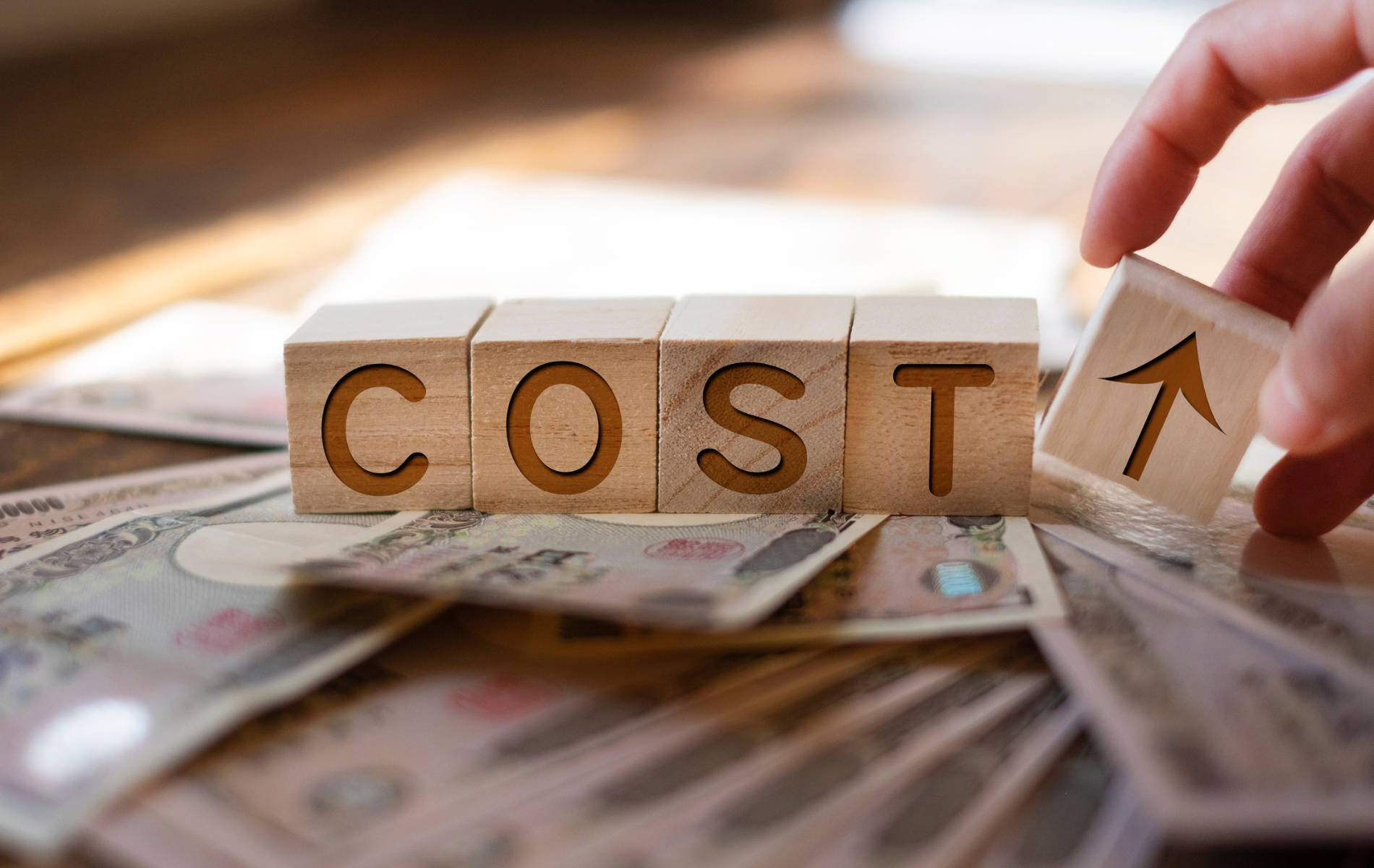 Yellow vinyl being fed into a wide-format cutting machine, person's hands visible.