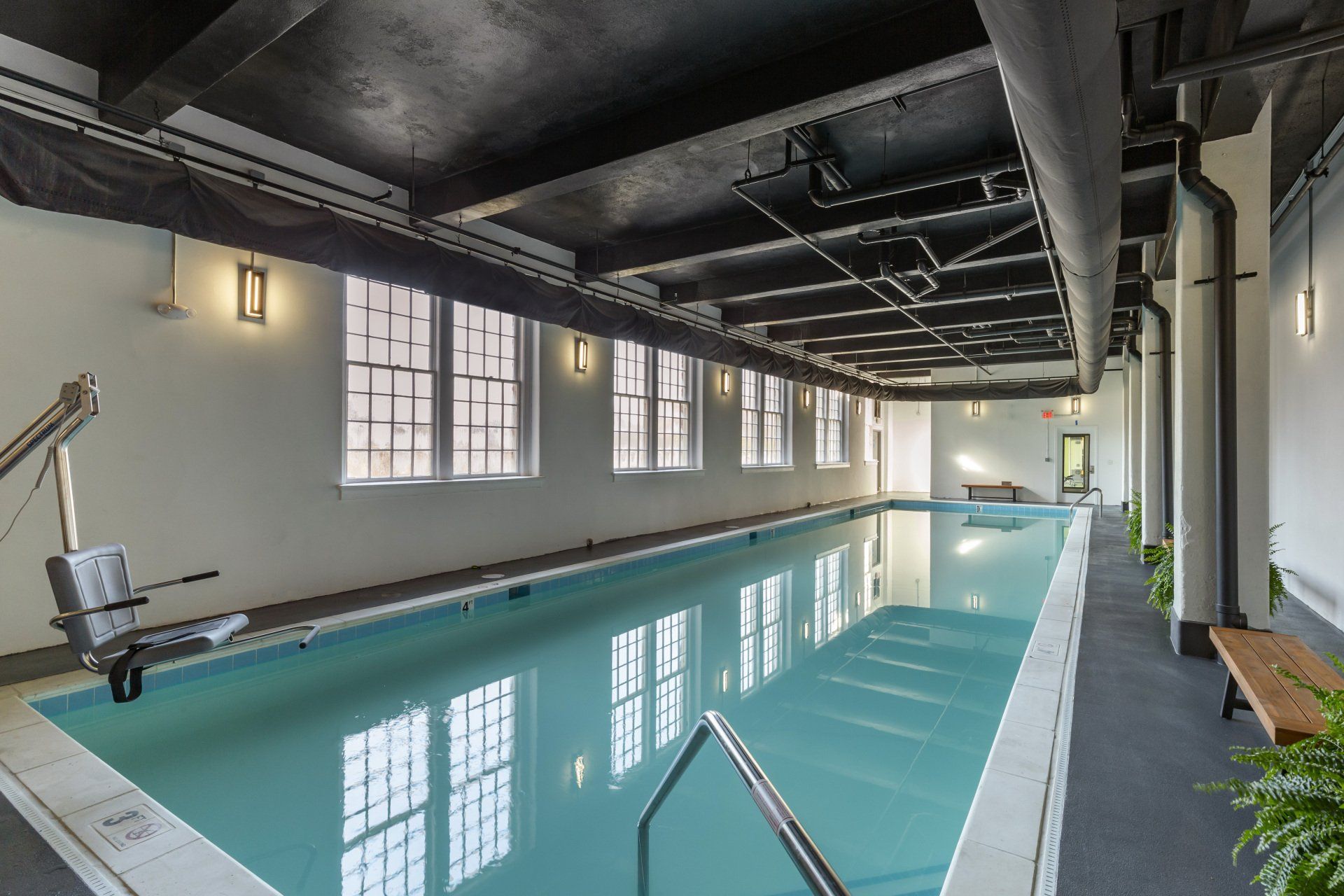 A large indoor swimming pool with stairs leading to it