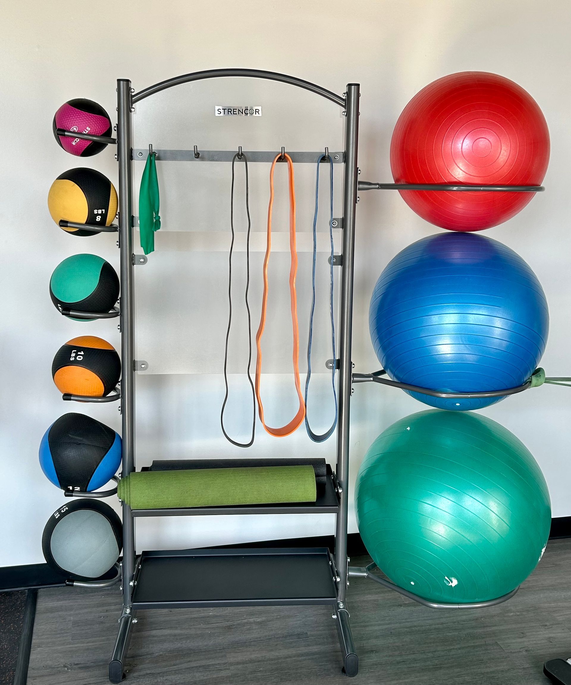 A bunch of exercise balls are stacked on top of each other