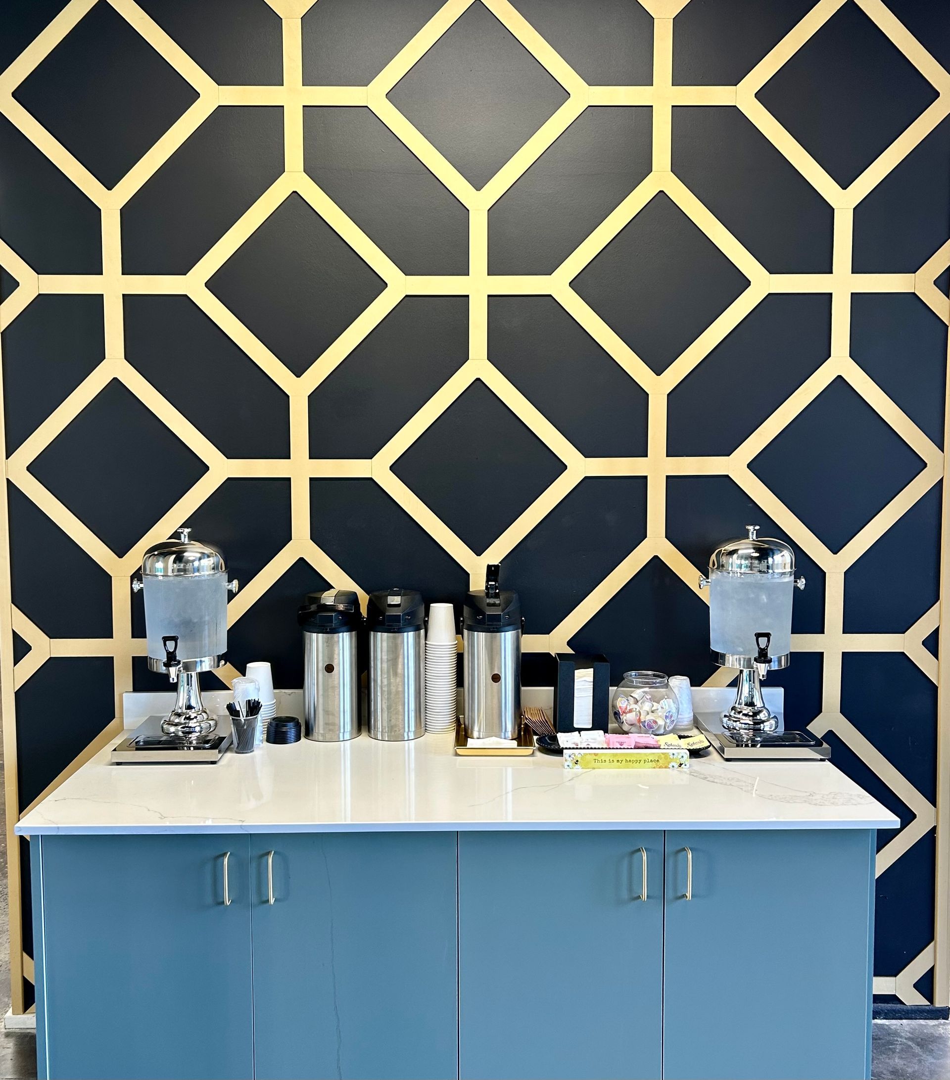 A counter with a black and gold wall behind it