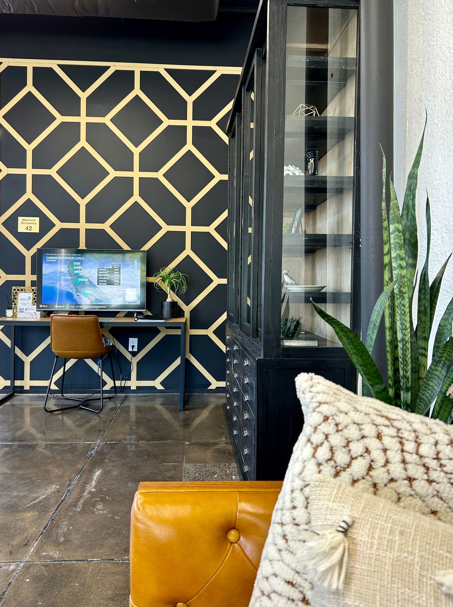 A living room with a desk and a computer on it