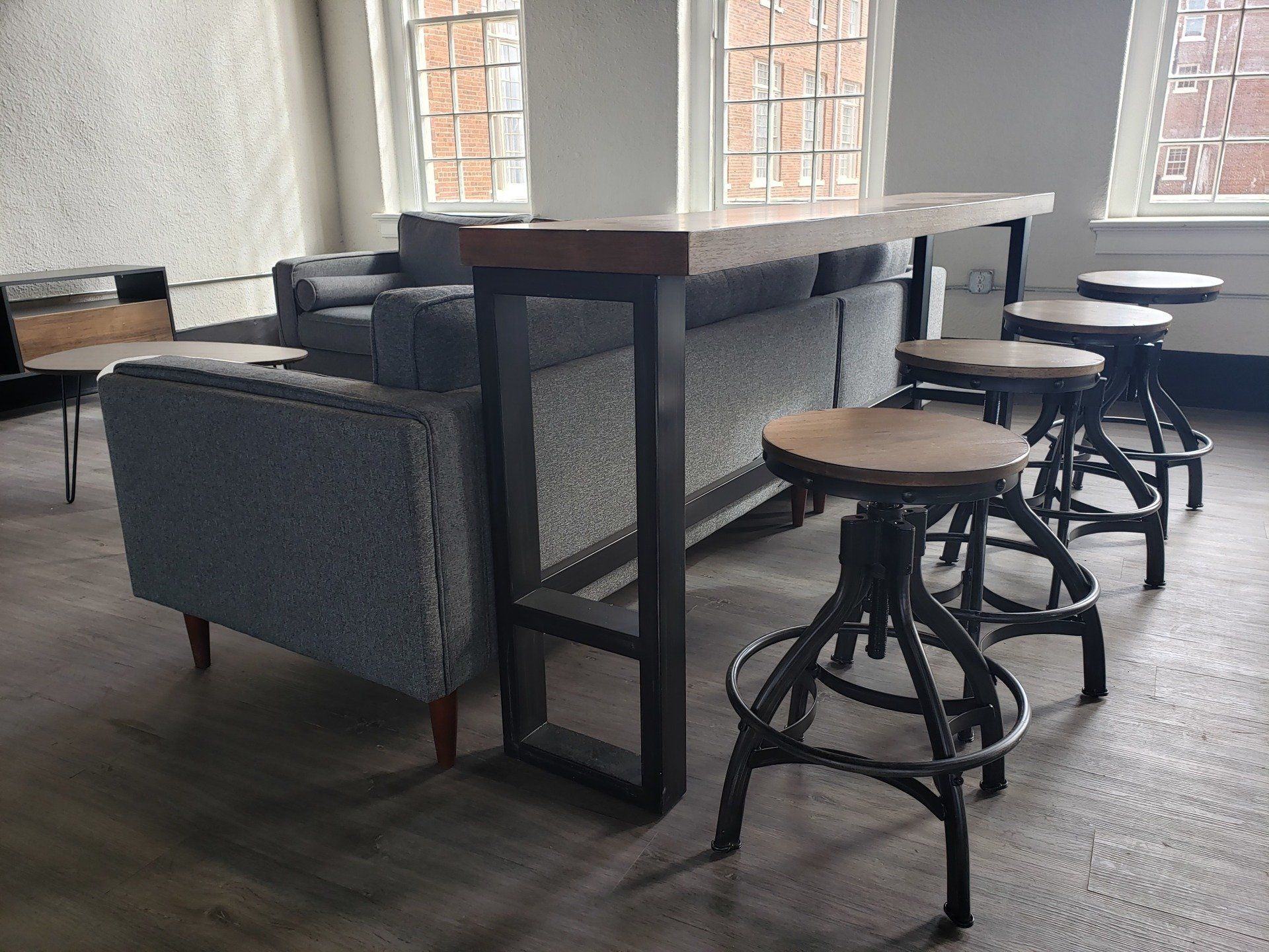 A living room with a couch , table and stools