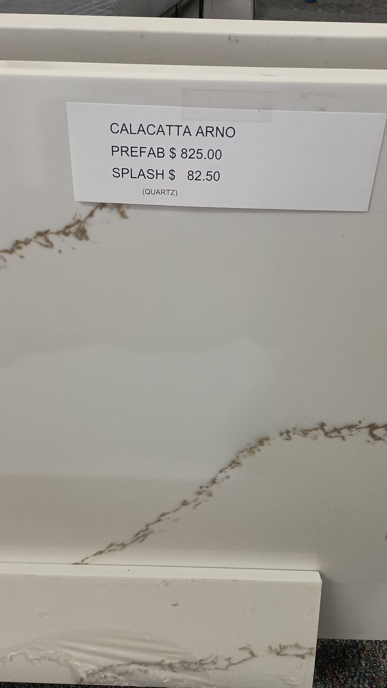 White countertop sample with brown veining Calacatta Arno.