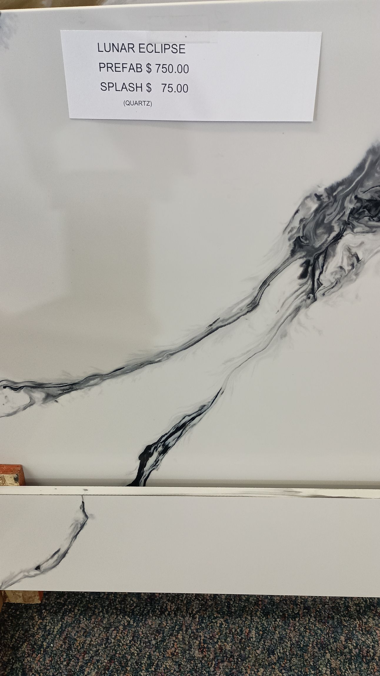 White counter top with black veining.