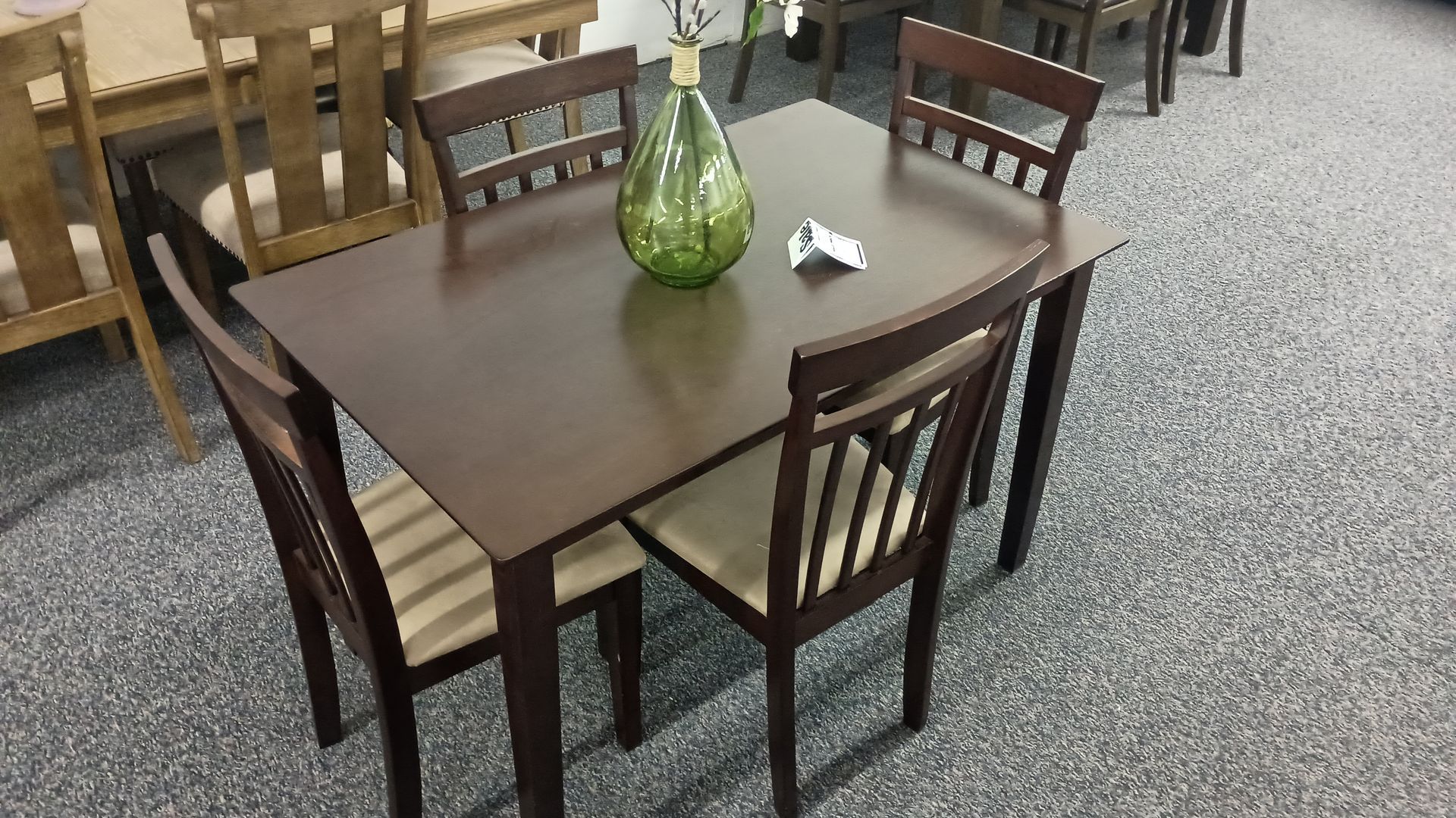 A dark wood dining table with four matching chairs