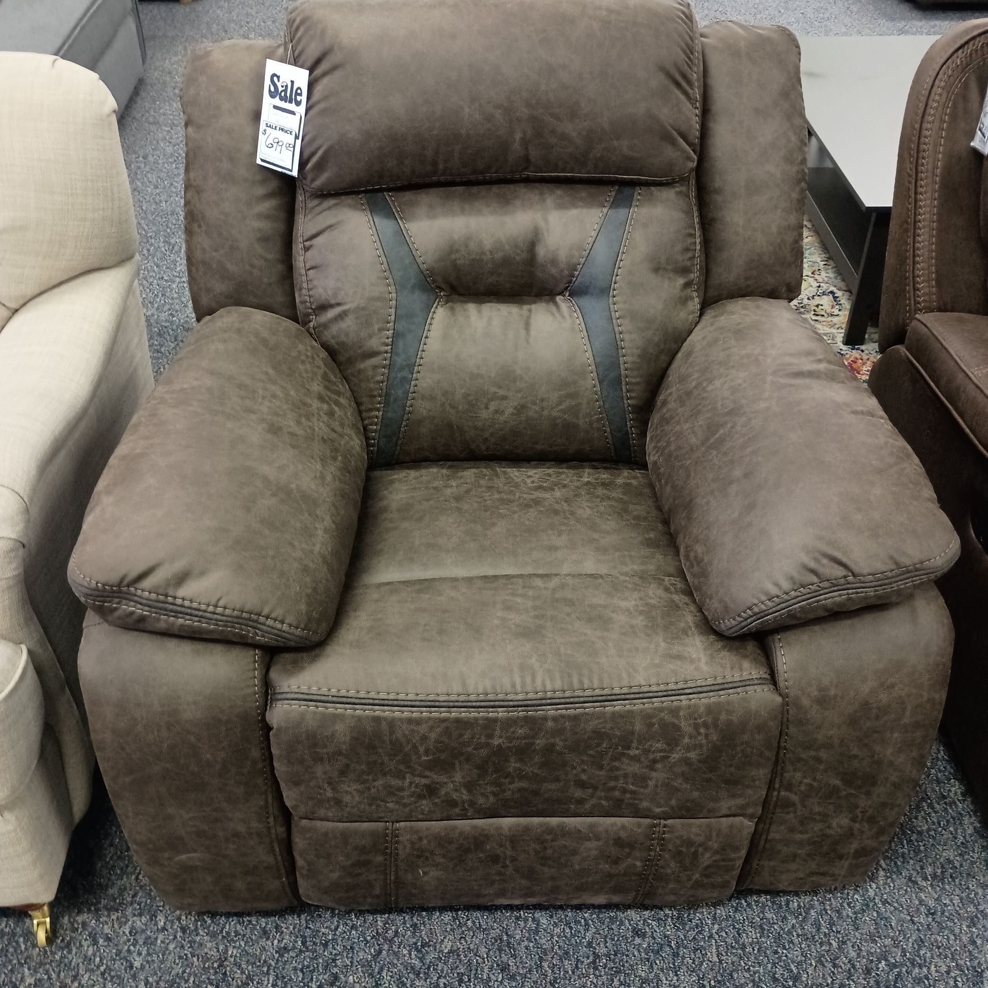 Brown leather recliner chair with padded arms and back