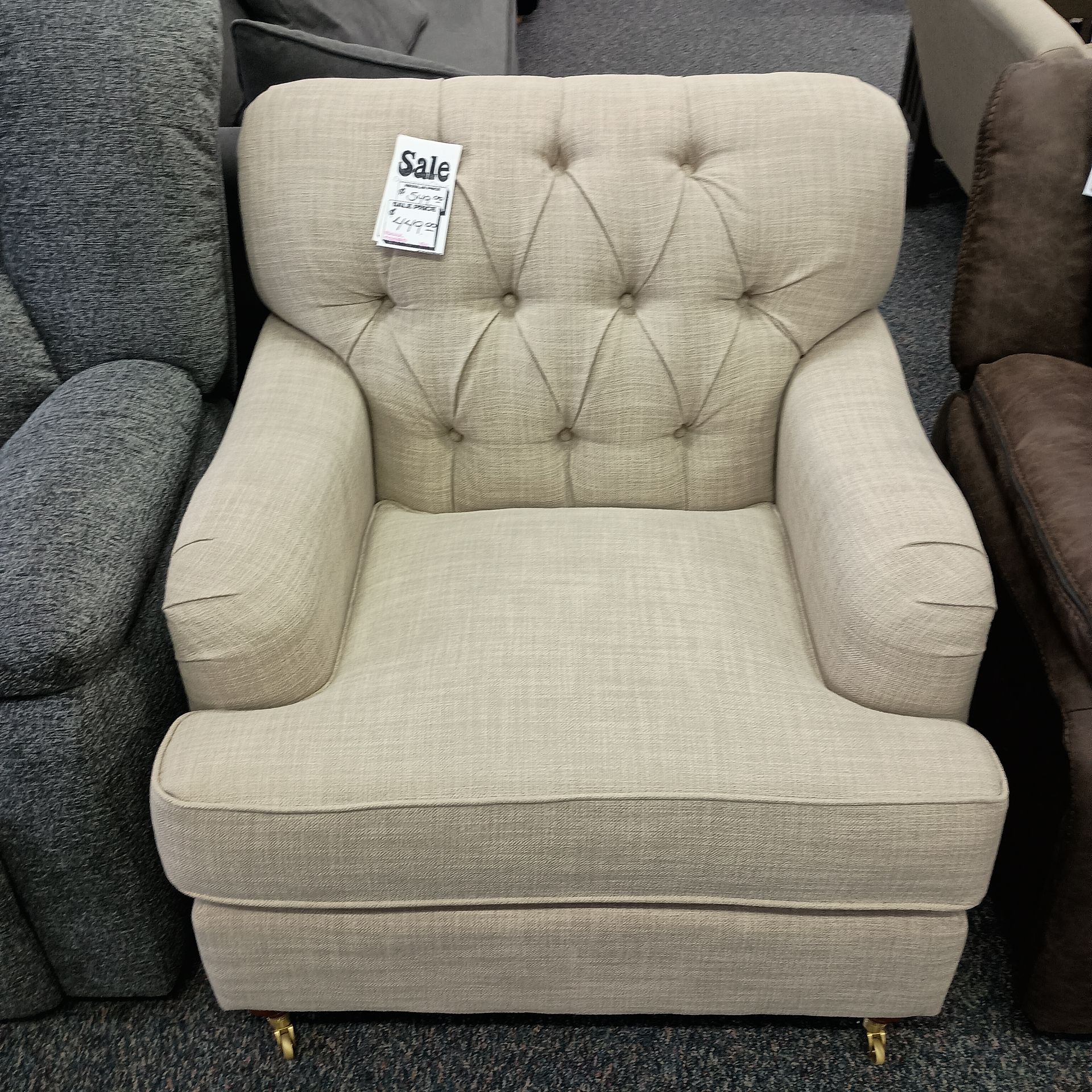 Beige upholstered armchair with buttoned back