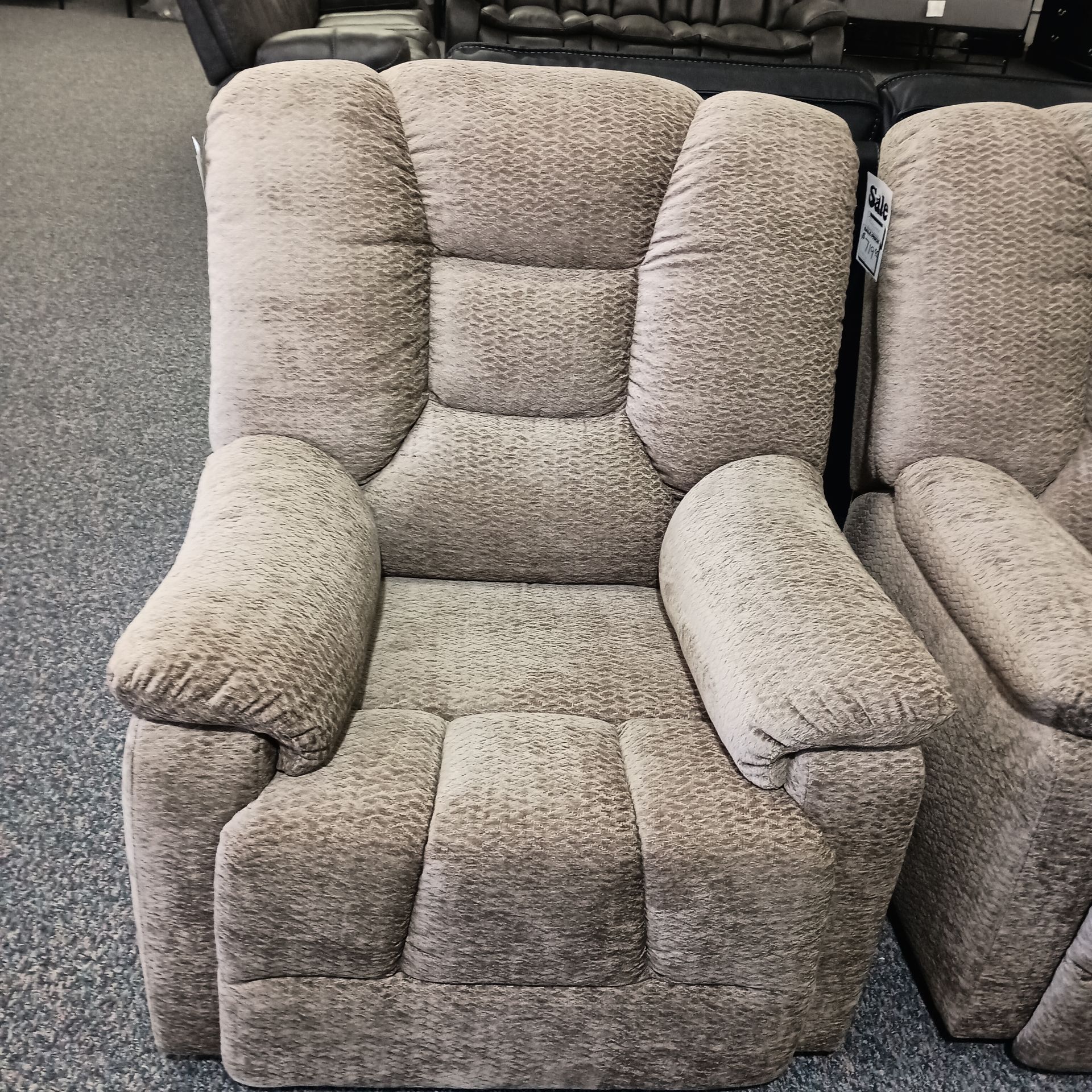 Tan upholstered recliner chair with padded arms